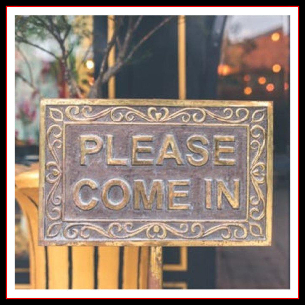 Photo of a sign in a door that reads: "Please Come In" 