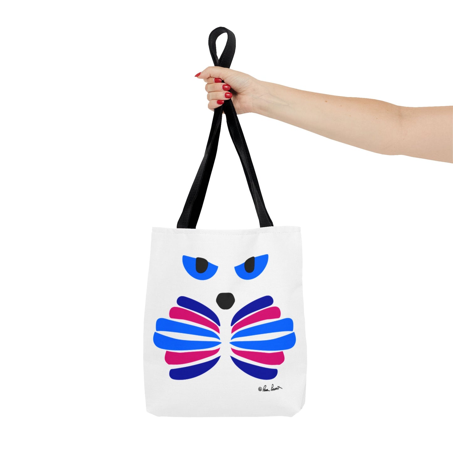 A hand displays Printify's Cat-Face Tote Bag featuring black handles and a vibrant owl design in blue, pink, and purple. This 2-sided polyester tote blends practicality and whimsy, ideal for cat lovers.