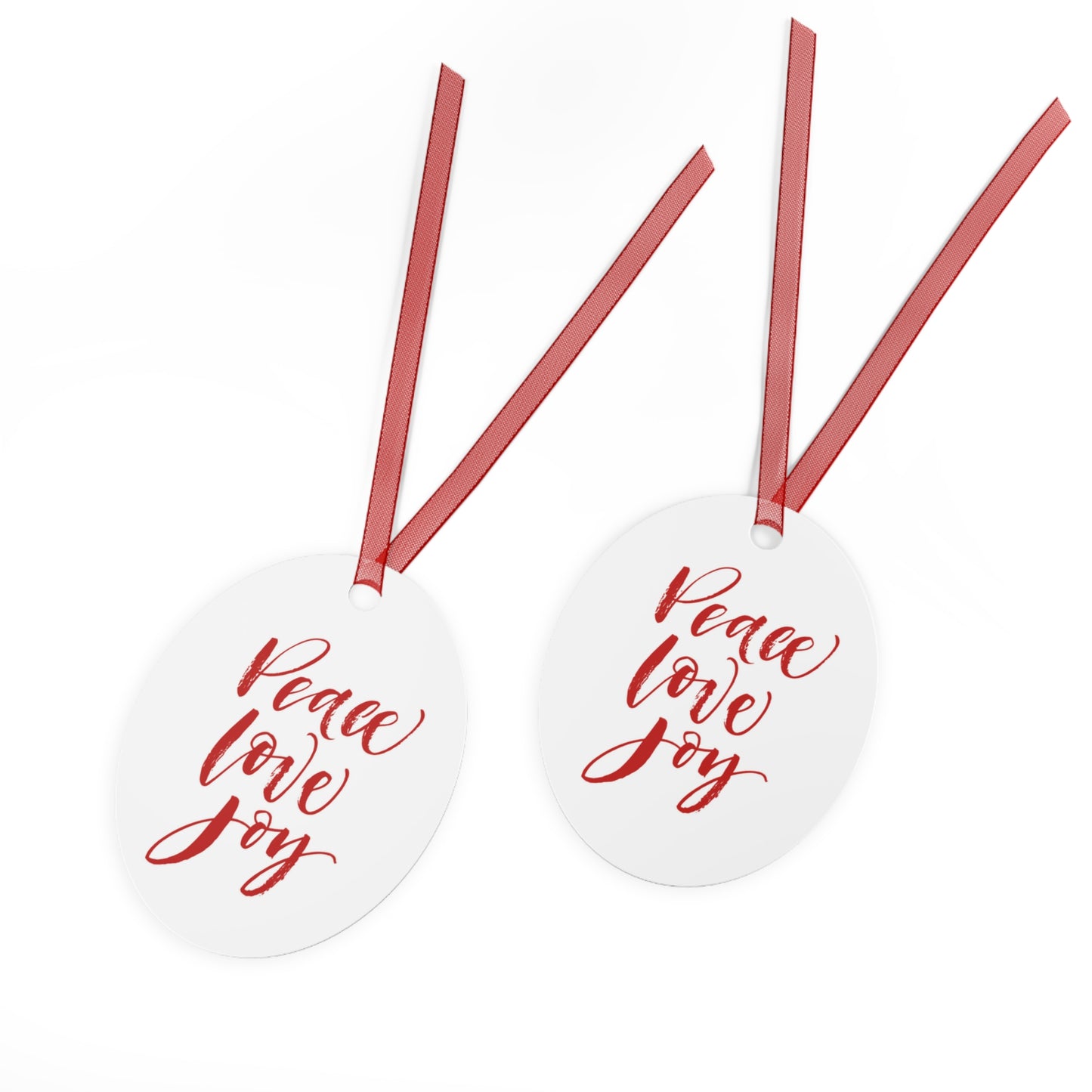 The Printify Holiday-Text Metal Ornaments, featuring an oval design and adorned with red hanging ribbons, elegantly showcase "Peace Love Joy" in red cursive text, making them charming holiday decor or Christmas tree decorations.