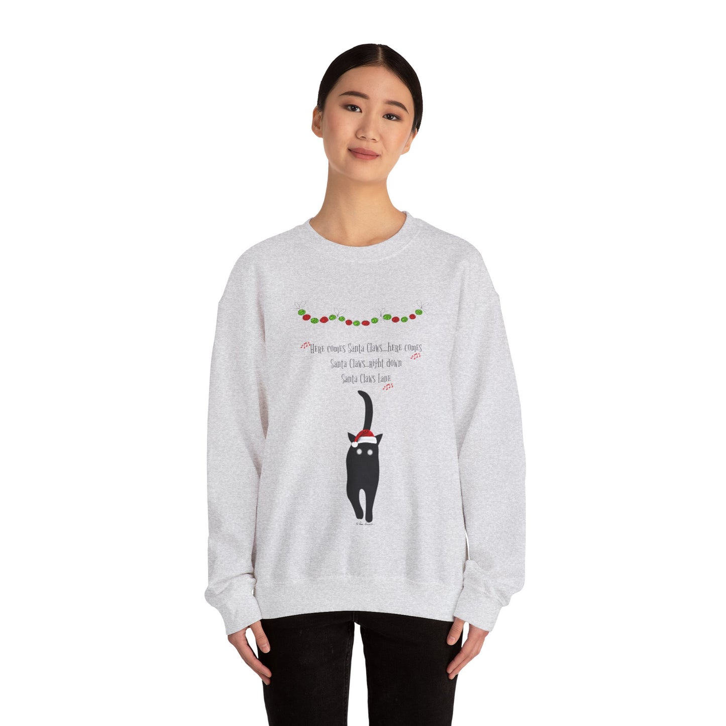 A person stands against a plain white background, wearing a cozy medium-heavy fabric Santa Claws Sweatshirt from Printify. This unisex sweater showcases a cat design along with playful festive text, perfectly capturing the holiday spirit. Available in three colors from Gildan.