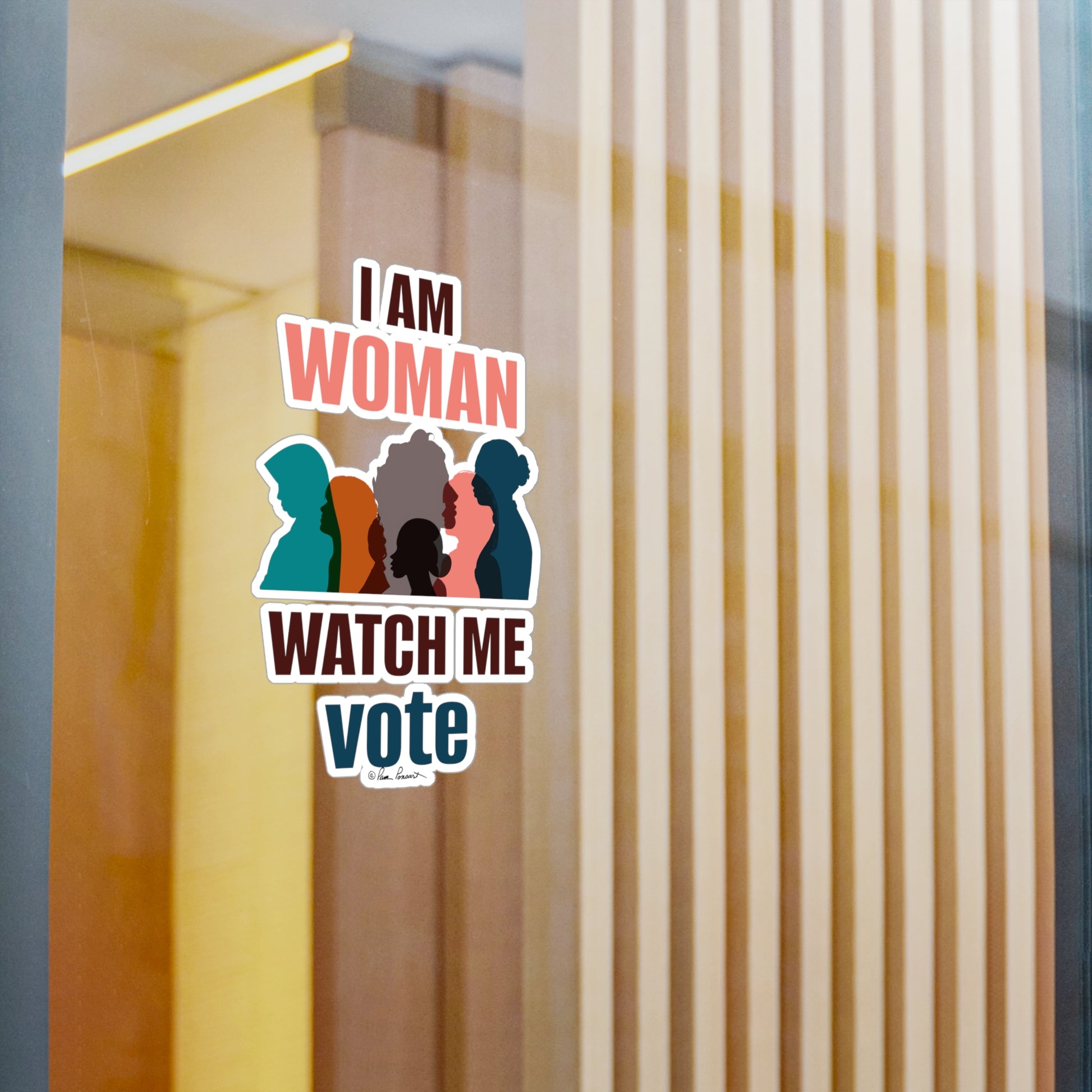 Sticker on a glass door reading "i am woman watch me vote" with silhouettes of three women, made from white vinyl, set against a blurred room background. Introducing the Voting Women's Decals by Printify: Unisex; 4 sizes; Vinyl; Graphics.