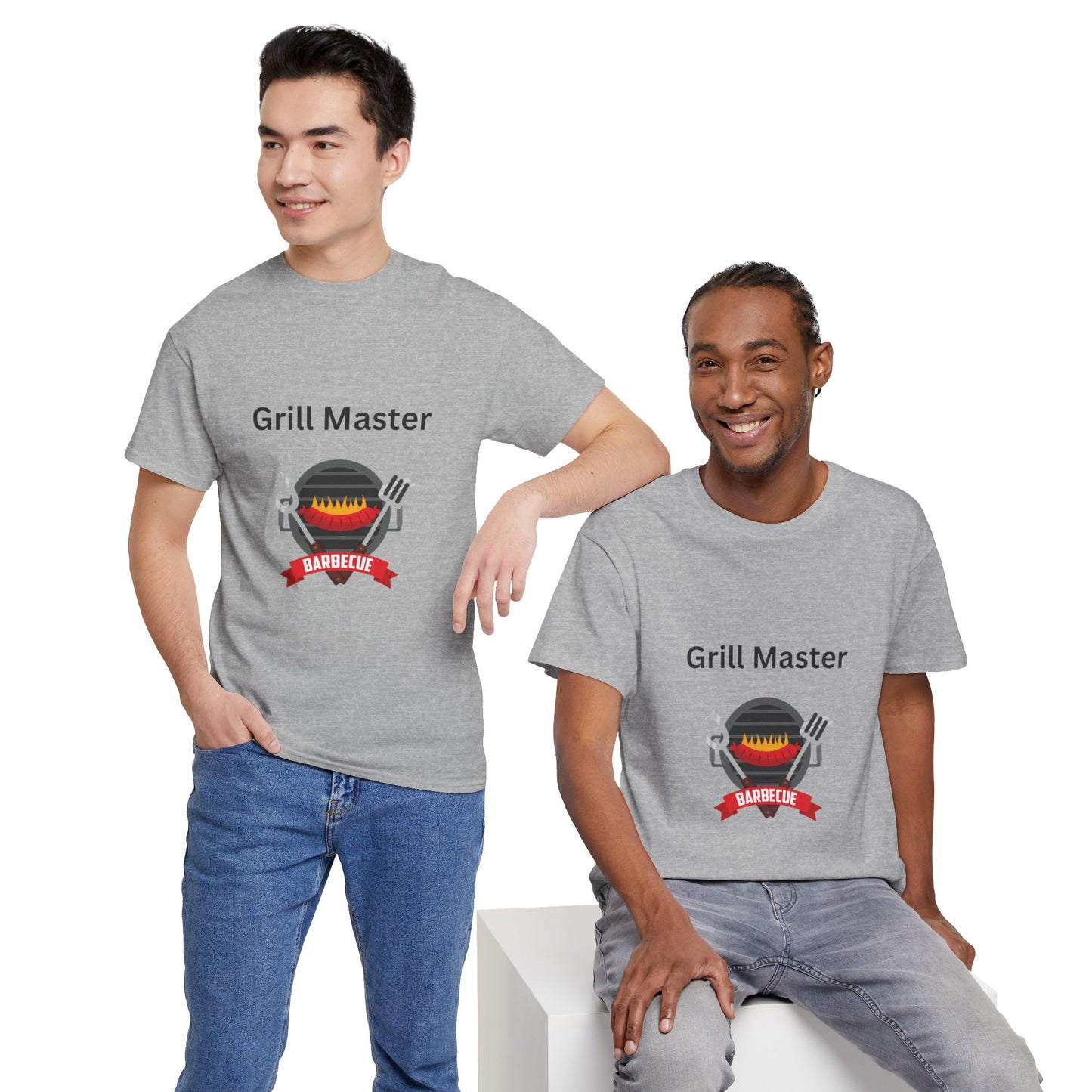 Two men wearing gray "Unisex Grill-Master T-shirts: 2 colors; Cotton; Gildan" from Printify with a barbecue graphic are smiling; one is standing with a hand in his pocket, and the other is seated. These unisex shirts, proudly made in America, capture the joy of grilling together.