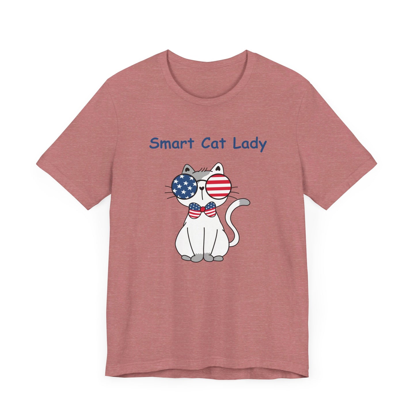 A pink Unisex Smart Cat-Lady T-shirt from Printify, made with Bella+Canvas cotton fabric, featuring a cartoon cat wearing American flag sunglasses and a bow tie, with the text "Smart Cat Lady." Perfect for showing off your patriotic flair!