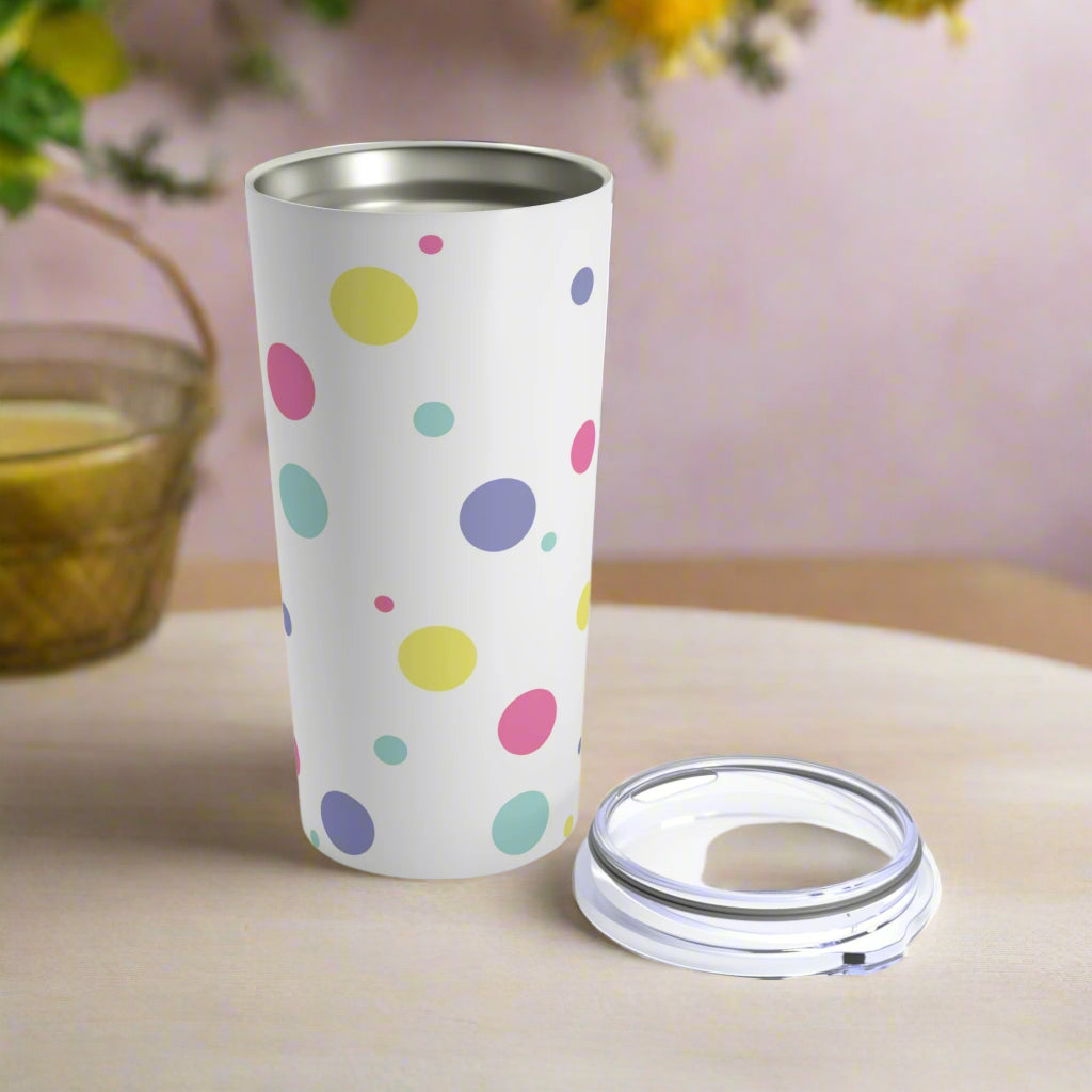 A colorful Printify Confetti Dots Tumbler with a lid.