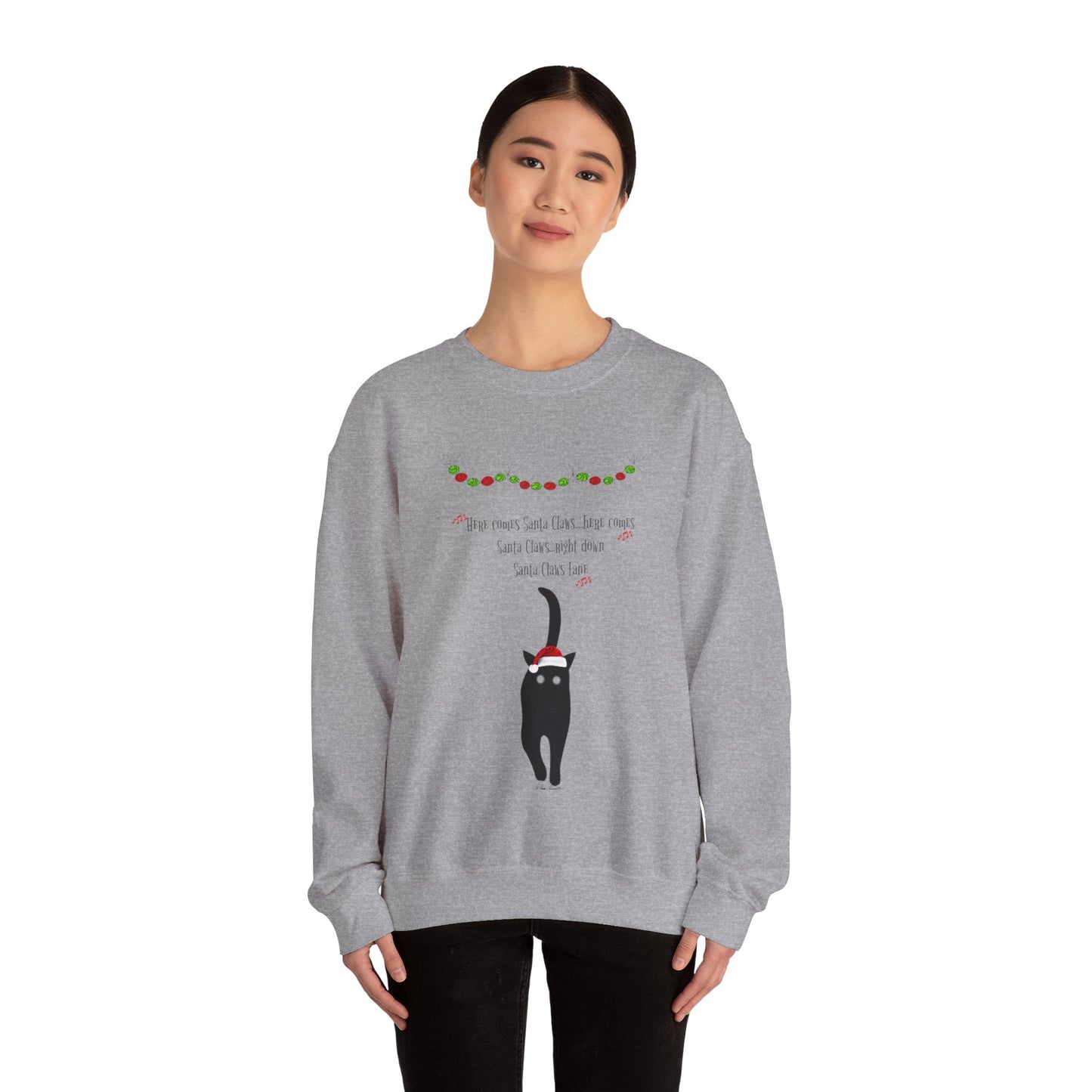 A person is wearing a Printify Santa Claws Sweatshirt, which is unisex and available in three festive colors. This Gildan sweatshirt features a black cat and a colorful design, making it perfect for the holiday season with its cozy medium-heavy fabric.