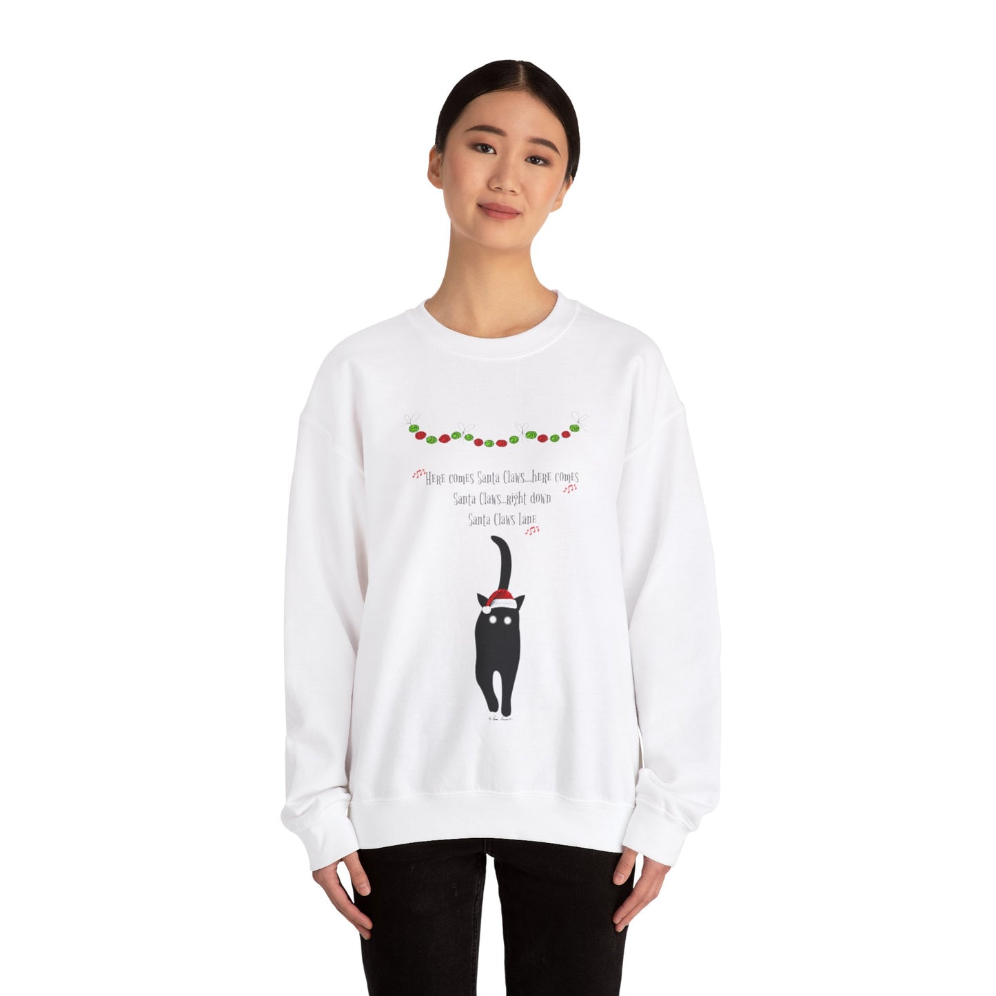 Someone wears the Santa Claws Sweatshirt by Printify, a medium-heavy fabric sweater ideal for the holiday season. This festive garment, featuring an adorable black cat with antlers, captures a whimsical spirit.