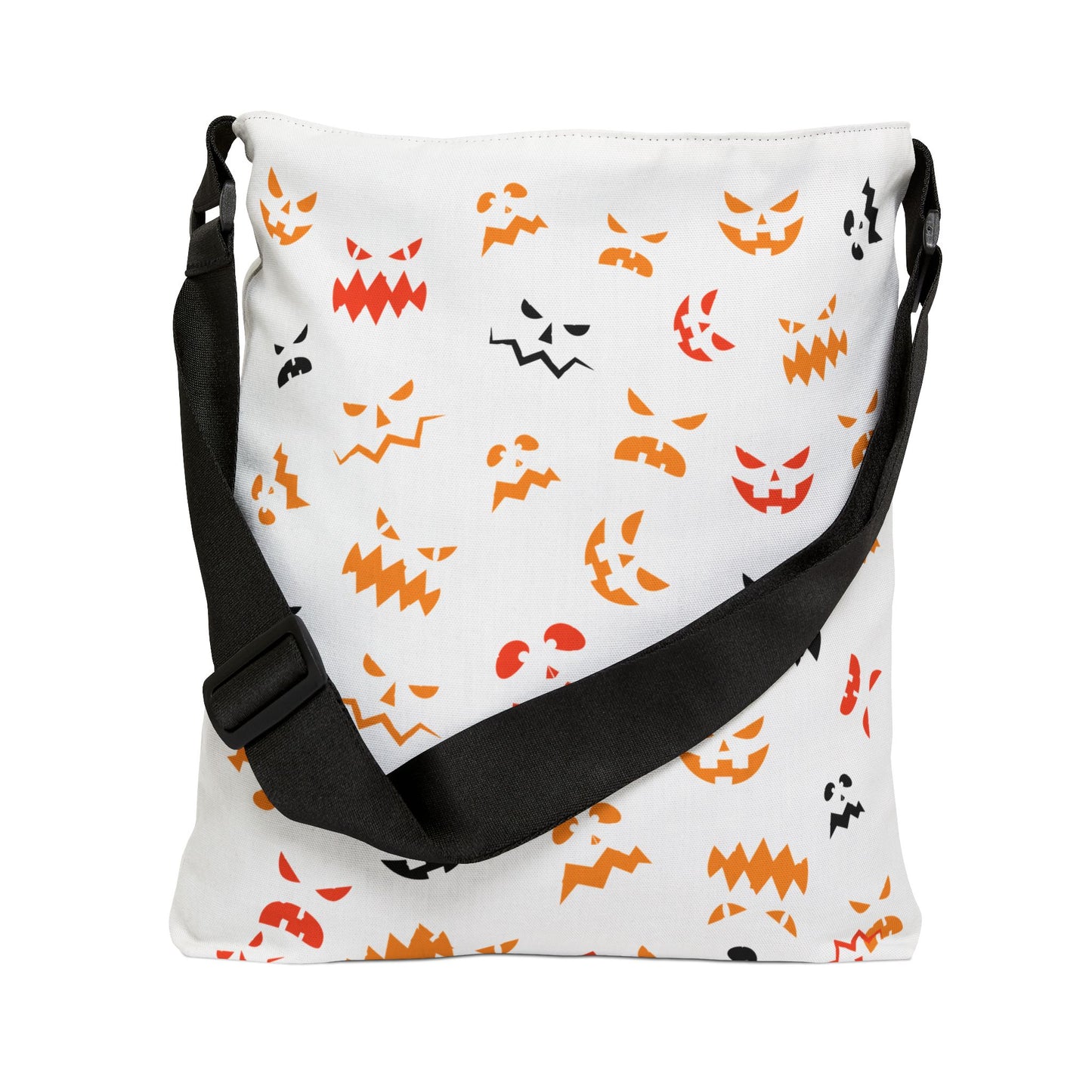 The Printify Halloween Adjustable Tote Bag: Spooky Trick or Treat sack features a white base, black strap, and vibrant jack-o'-lantern faces in orange, red, and black with unique spooky expressions.