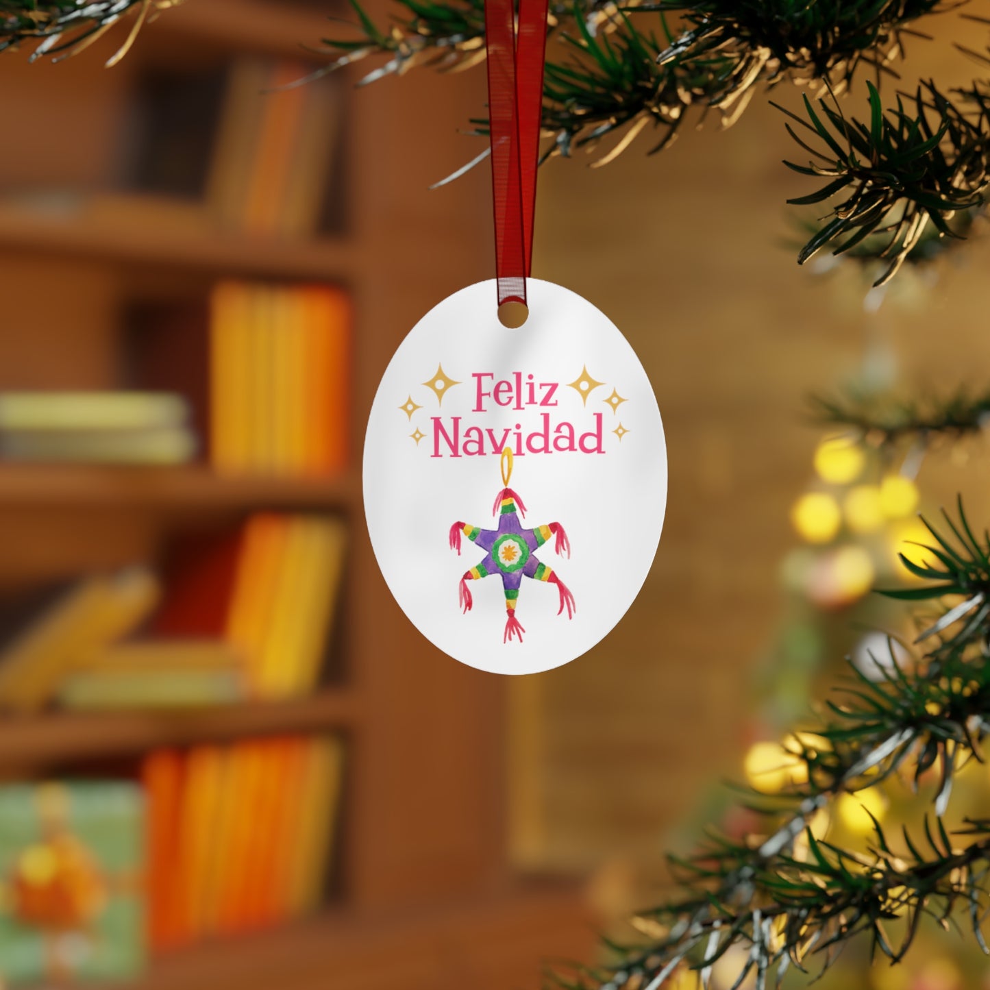 A festive charm from Printify's oval-shaped, metal "Feliz Navidad" ornament adorns the Christmas tree branch. It features the joyful text "Feliz Navidad" complemented by a lively piñata illustration amidst vibrant decorations.
