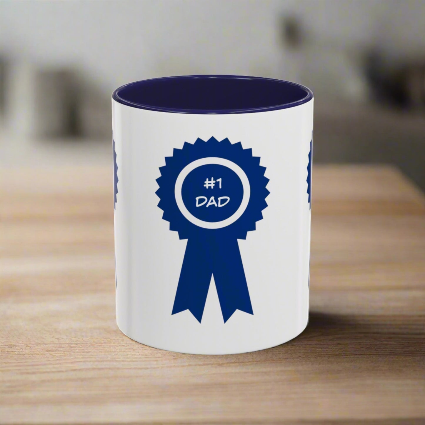 A white custom mug with a blue ribbon design that reads "#1 Dad," placed on a wooden surface. Printify's Dad's Special Mug: Unisex; 11 oz, Ceramic; Accented graphics is both dishwasher and microwave safe, ensuring convenience along with its heartfelt message.