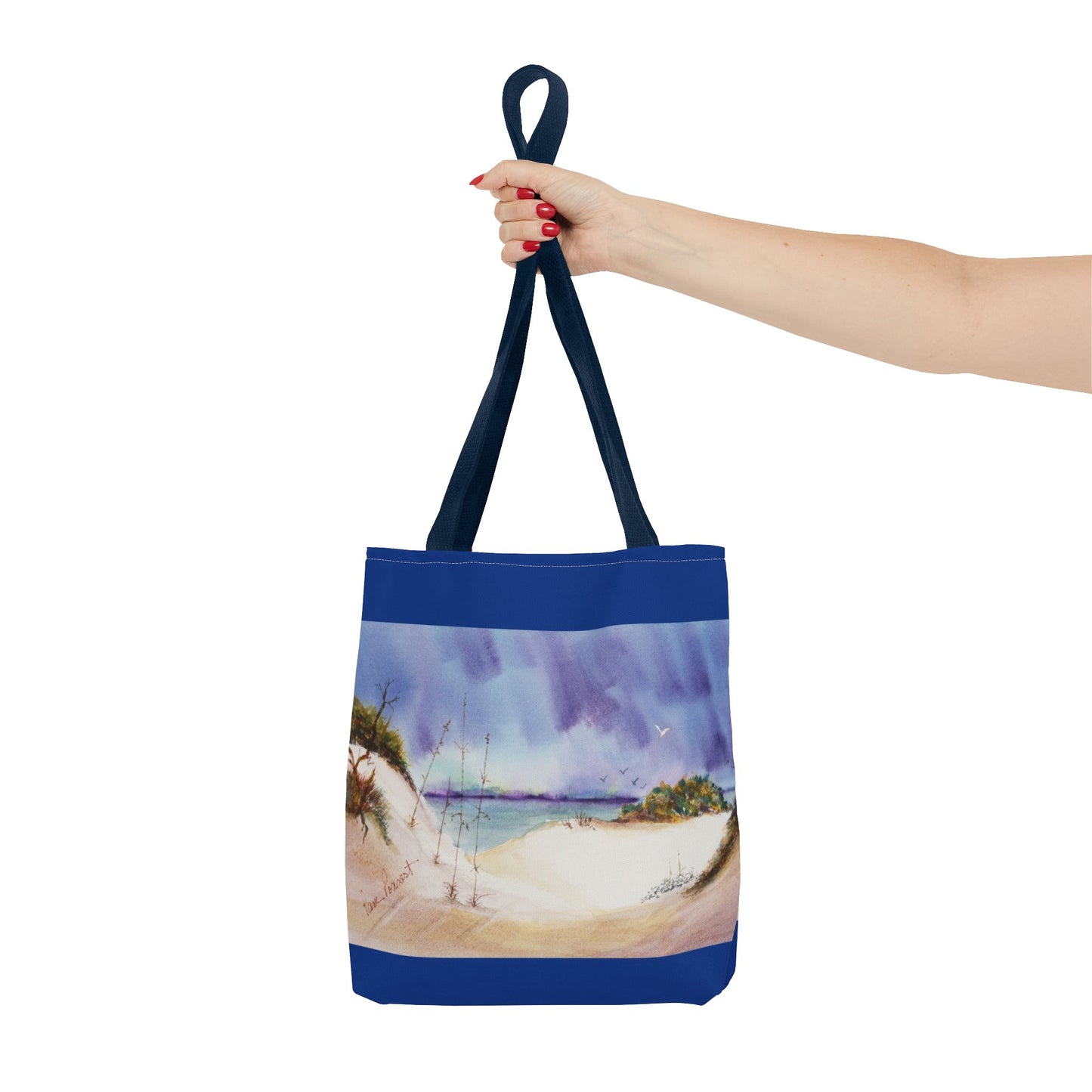 A hand holds a Printify Seaside Tote Bag, featuring a vibrant beach scene on both sides, ideally crafted for summer adventures and beach outings. Available in 3 sizes and made of polyester.