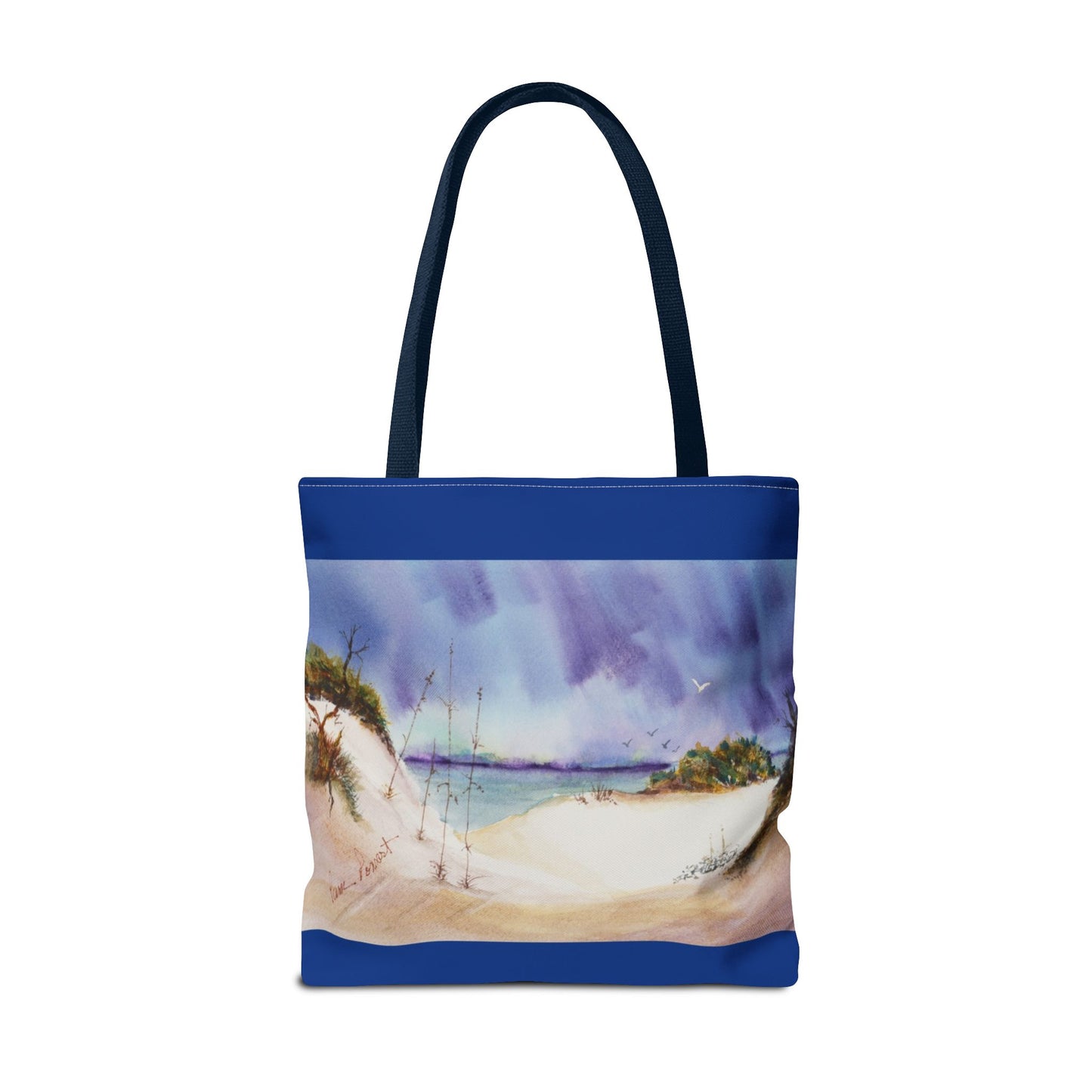 The Seaside Tote Bag by Printify, made from polyester and available in 3 sizes, features a two-sided design with blue handles and a vivid print of sand dunes, the ocean, and a cloudy sky—perfect for beach outings!.