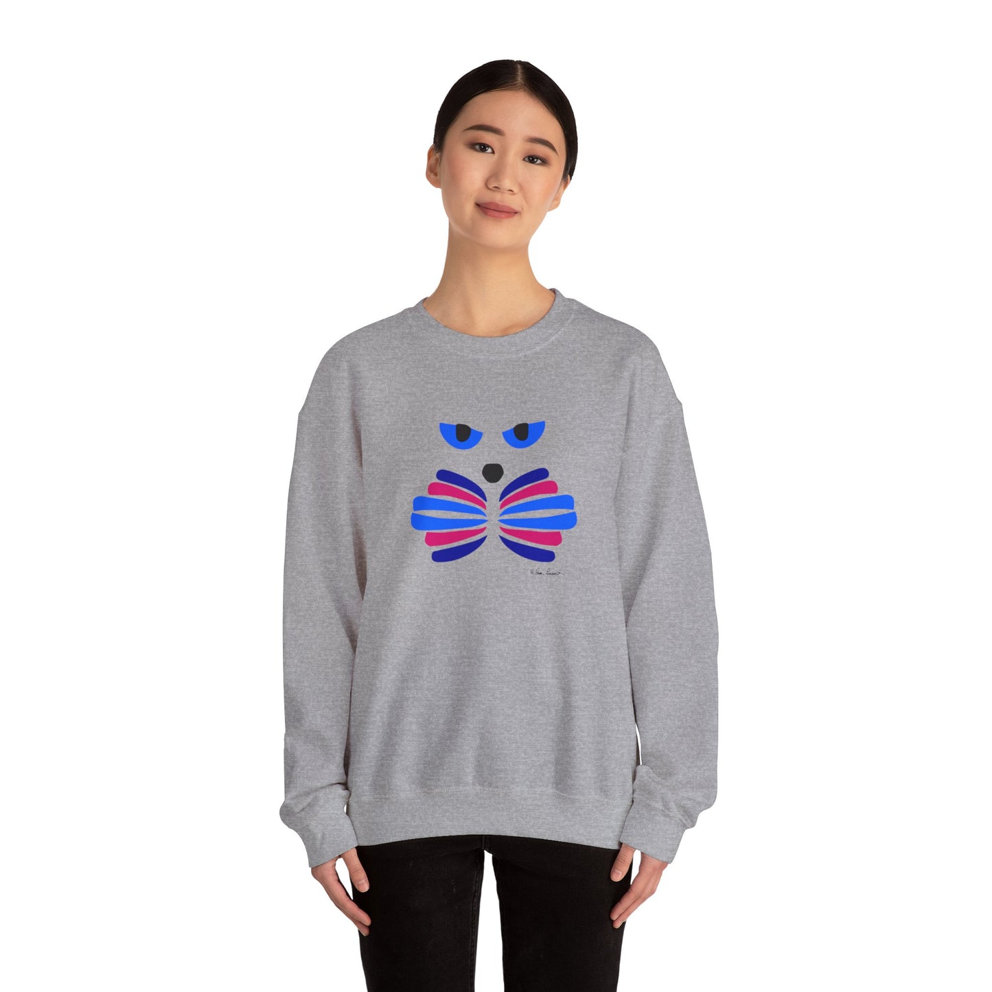 A person wearing a gray Printify Unisex Cat-Art Sweatshirt, featuring a colorful abstract design on the front, is standing against a plain white background.