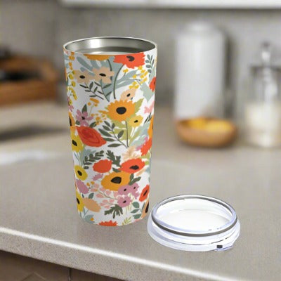 A Printify Summer Flowers Tumbler: 20 oz.; Stainless steel; Insulated with a lid.