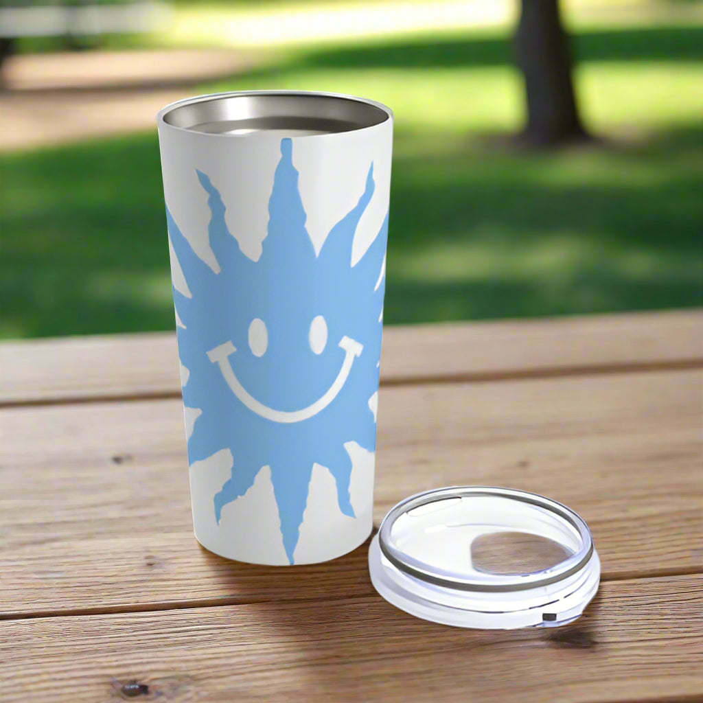 An insulated stainless steel Blue Happy-Face Tumbler with a blue sun on it from Printify.