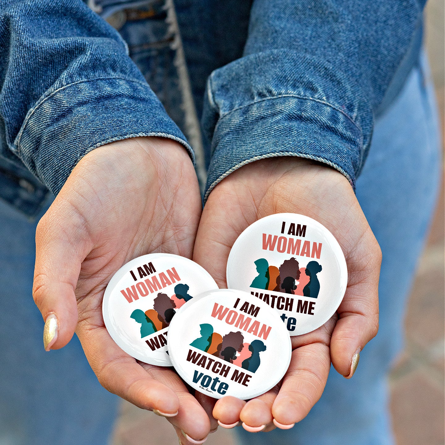 Woman holding 3 buttons in her cupped hands