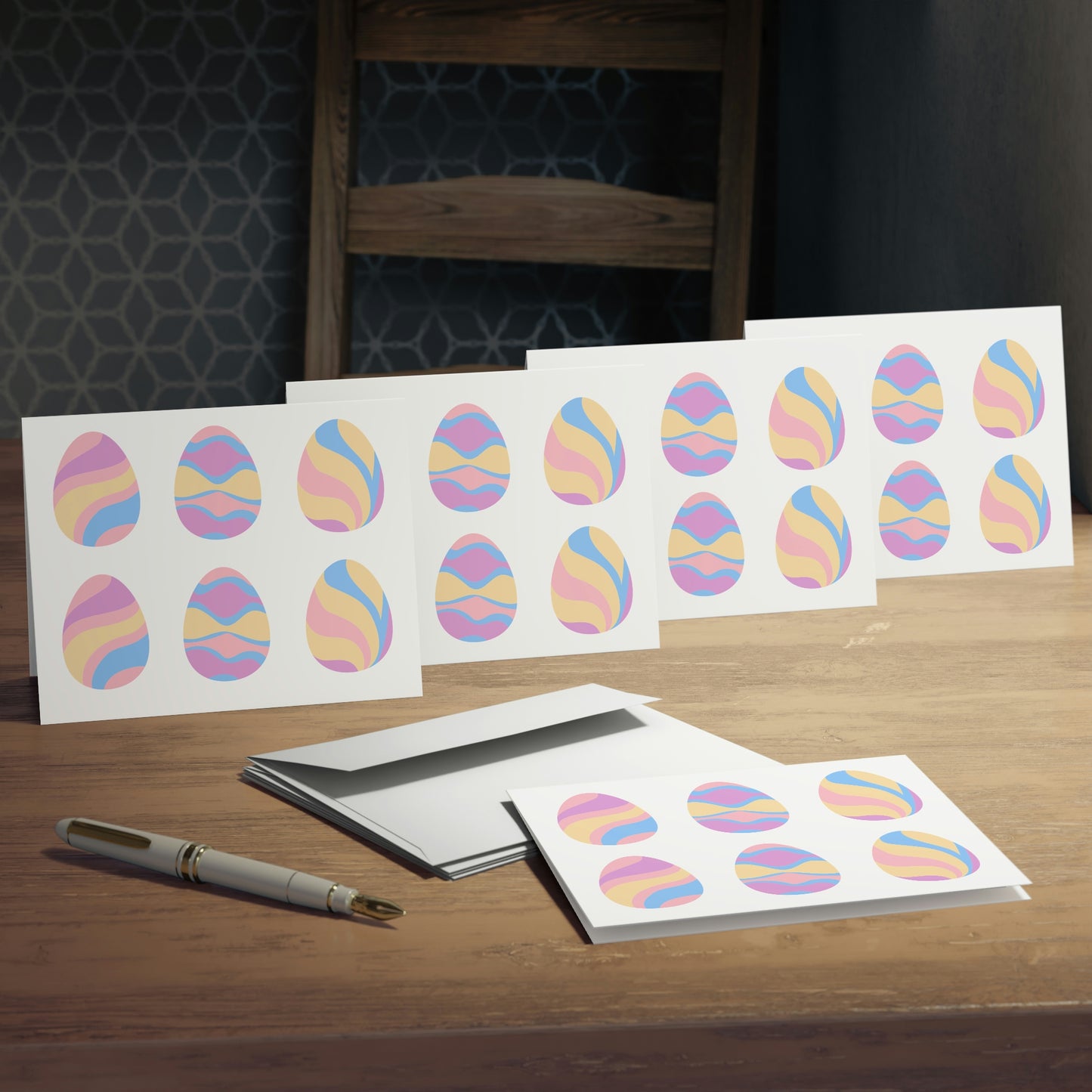 Mock up of the 5 note cards with an envelope and pen on a surface