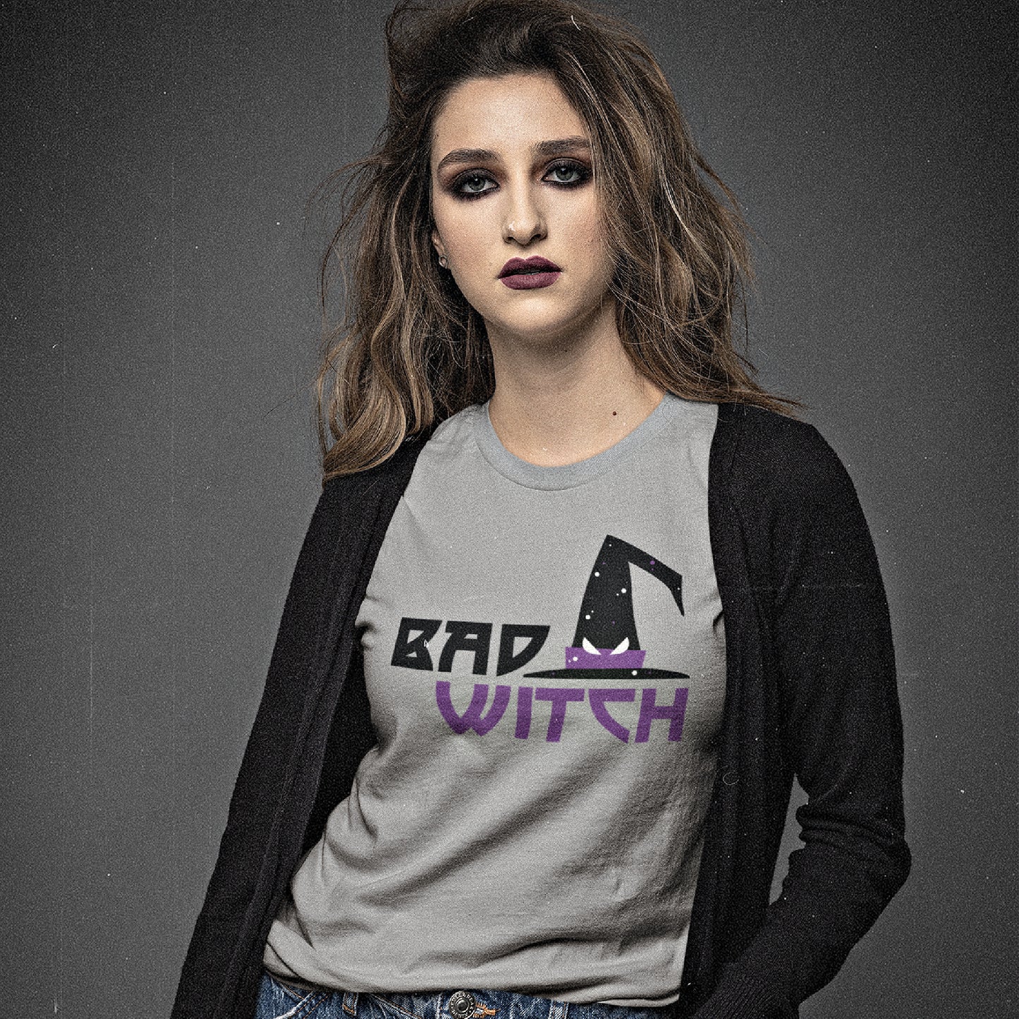 A mock-up of a serious young woman at a studio wearing our Womens Bad-Witch T-shirt