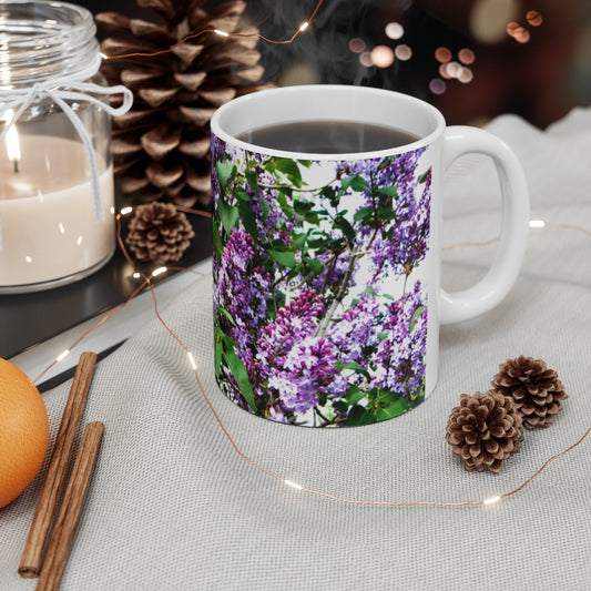 Mock up of our Purple Lilacs Mug on a table next to 2 small pine cones