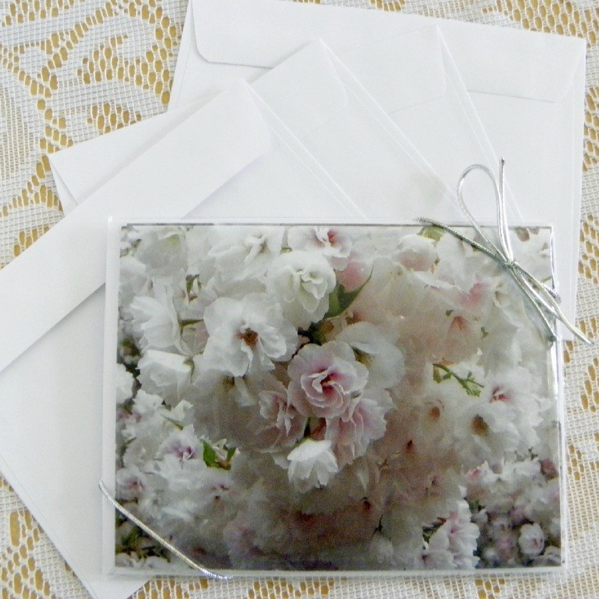 Photo of the 4-piece set of Wedding-Floral Note Cards adorned with a silver stretch-tie and bow