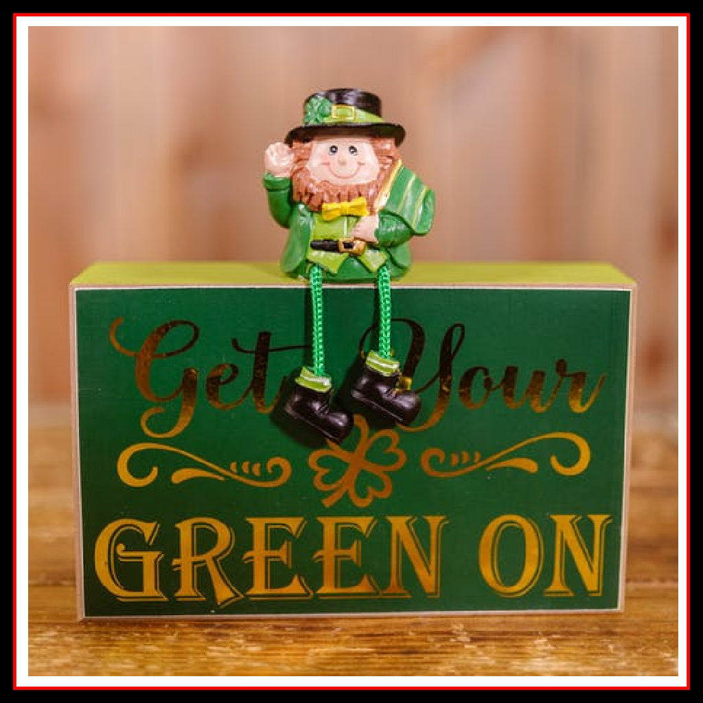 Little Leprechaun sitting on a sign which reads "Get Your Green On"