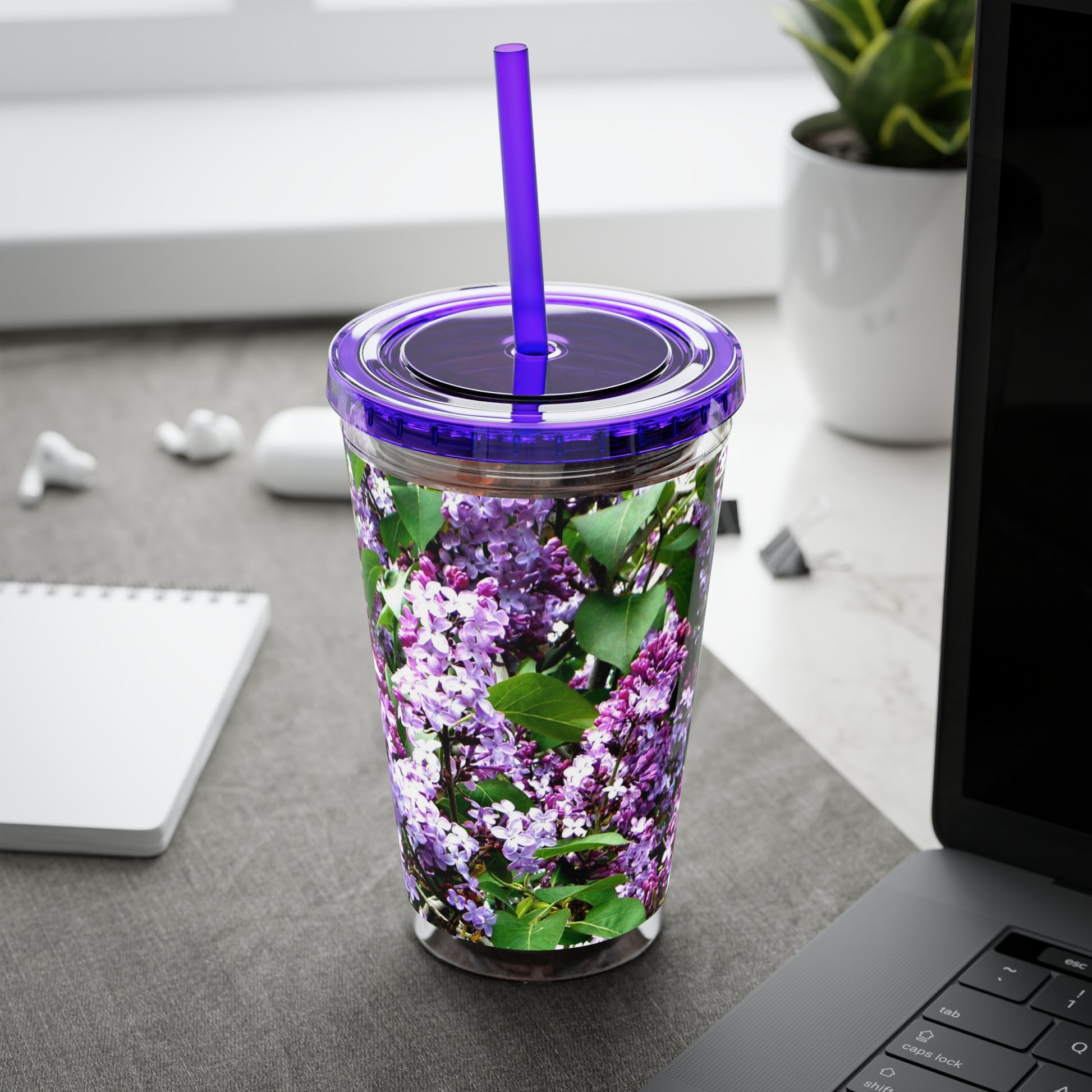 A Purple Lilacs Tumbler with a straw.
