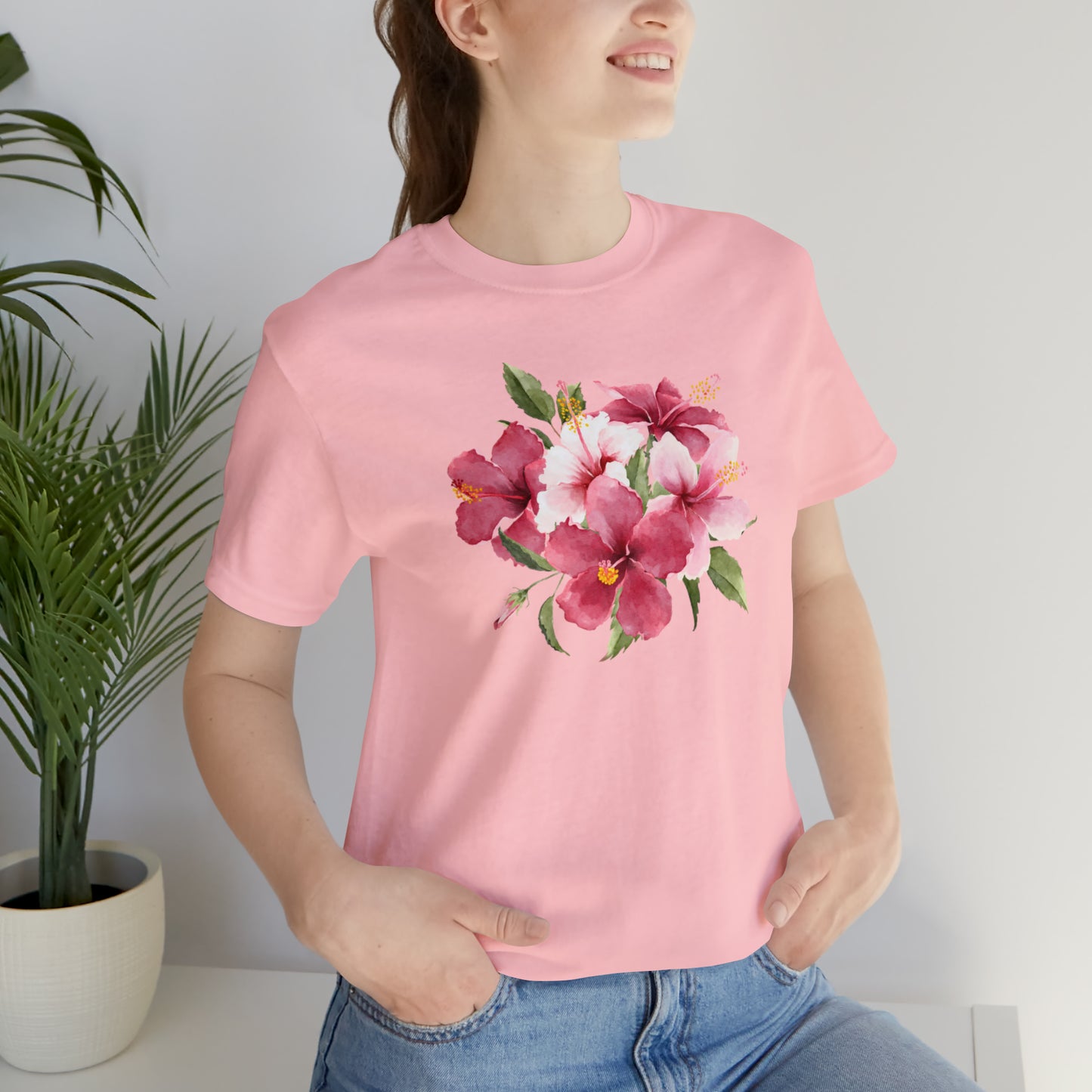Mock up of a woman wearing the pink shirt while sitting on a surface