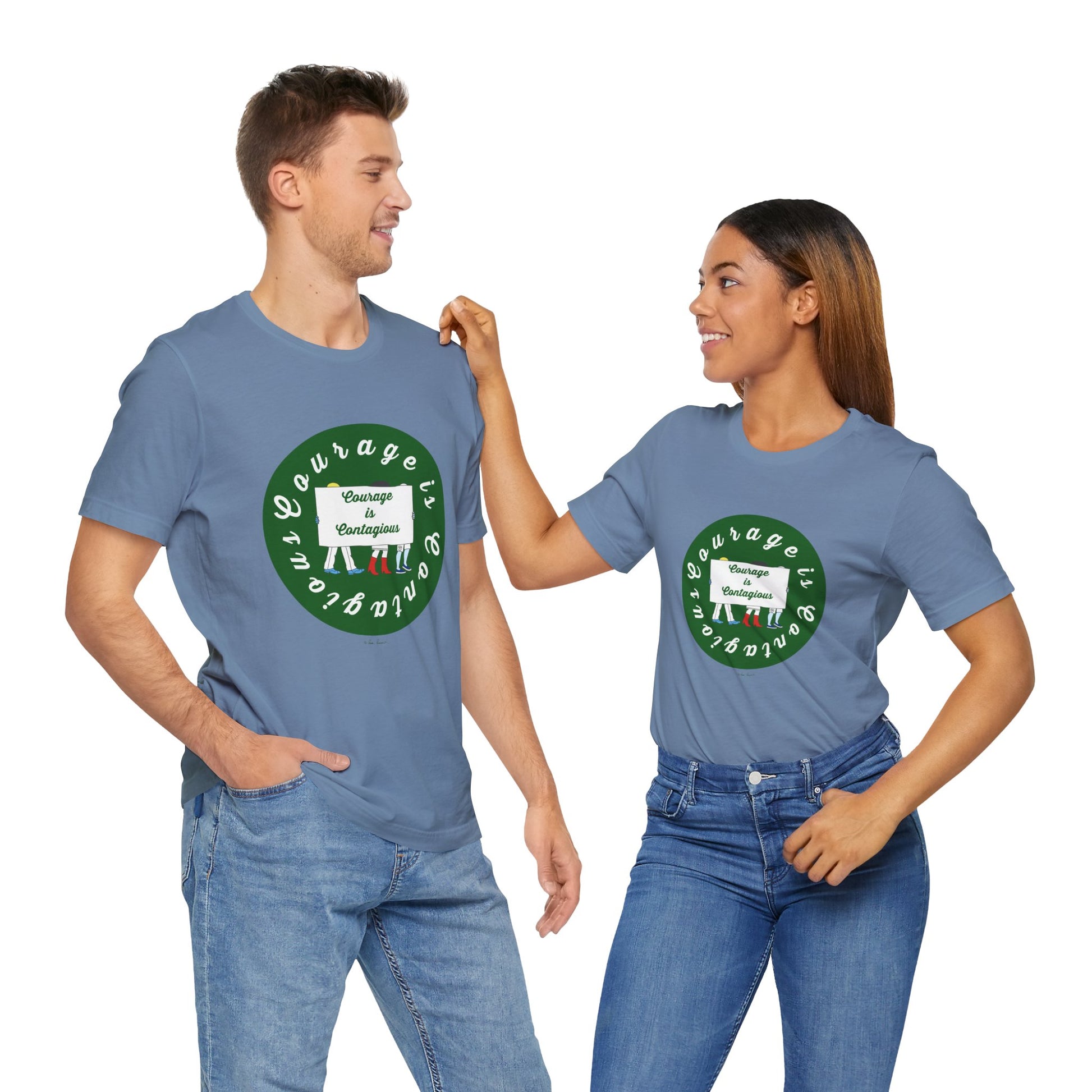 Two people wearing matching Printify Courage Is Contagious T-shirts—unisex activist graphic tees—stand and smile at each other.