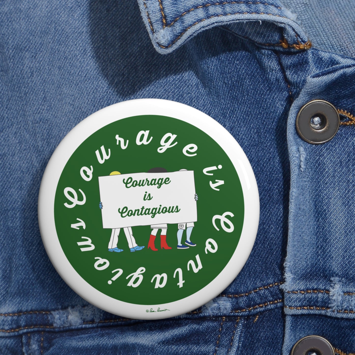 Button badge with 'Courage is Contagious' text on a denim jacket