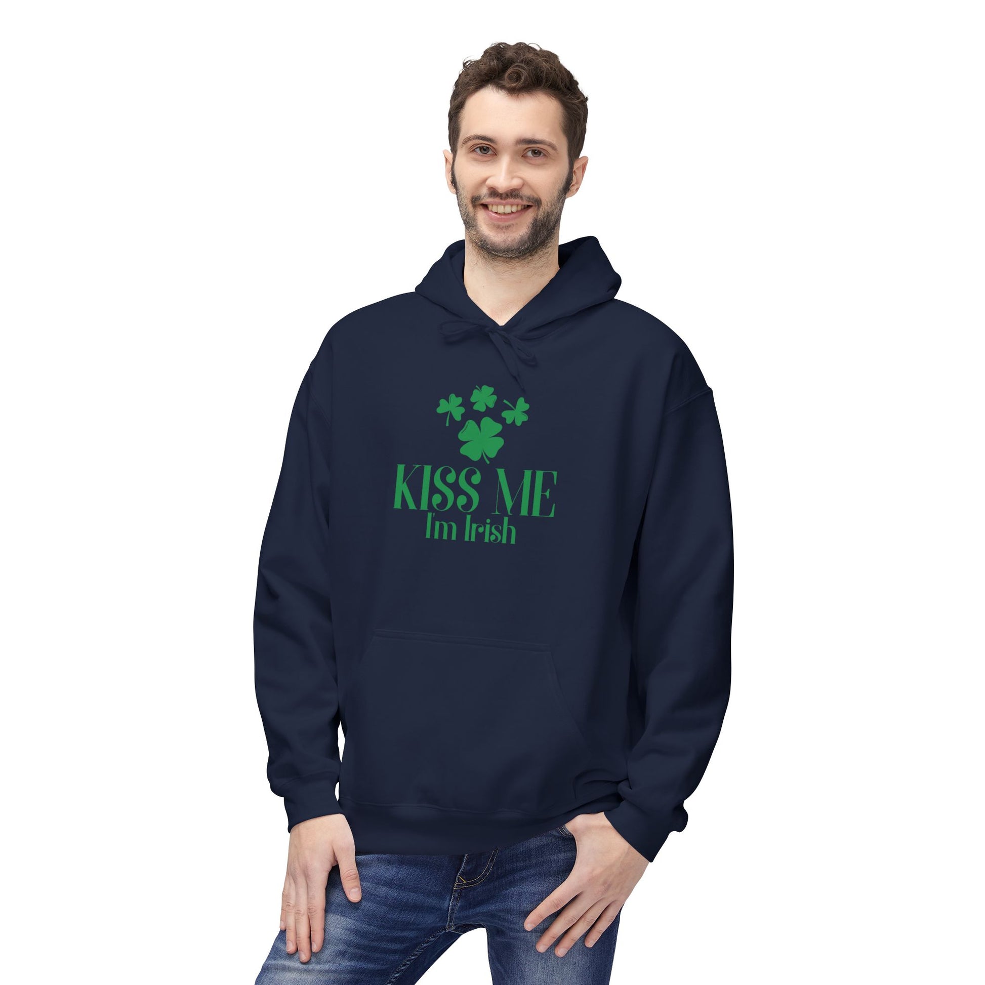 A man smiles while wearing the Printify Kiss-Me I'm Irish Hoodie: St. Patricks Day Shamrock Pullover, featuring green shamrocks and "Kiss Me I'm Irish" on the front, proudly showing his festive spirit.