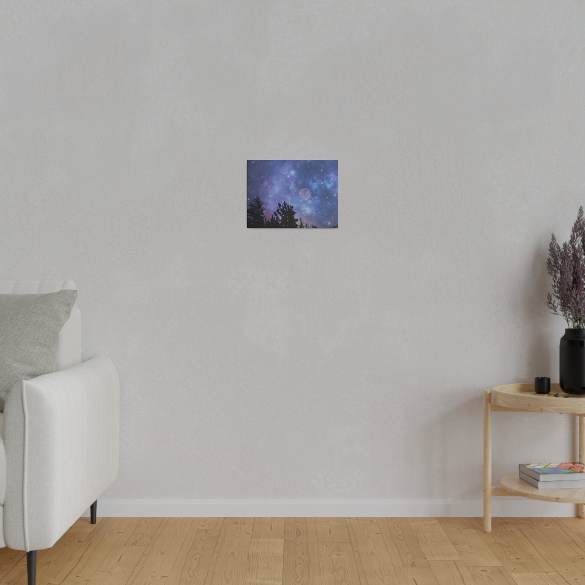 A minimalistic room with a white sofa, a wooden side table, and an astrological Printify Blue-Moon Matte Canvas wall art hanging on a radial pine frame.