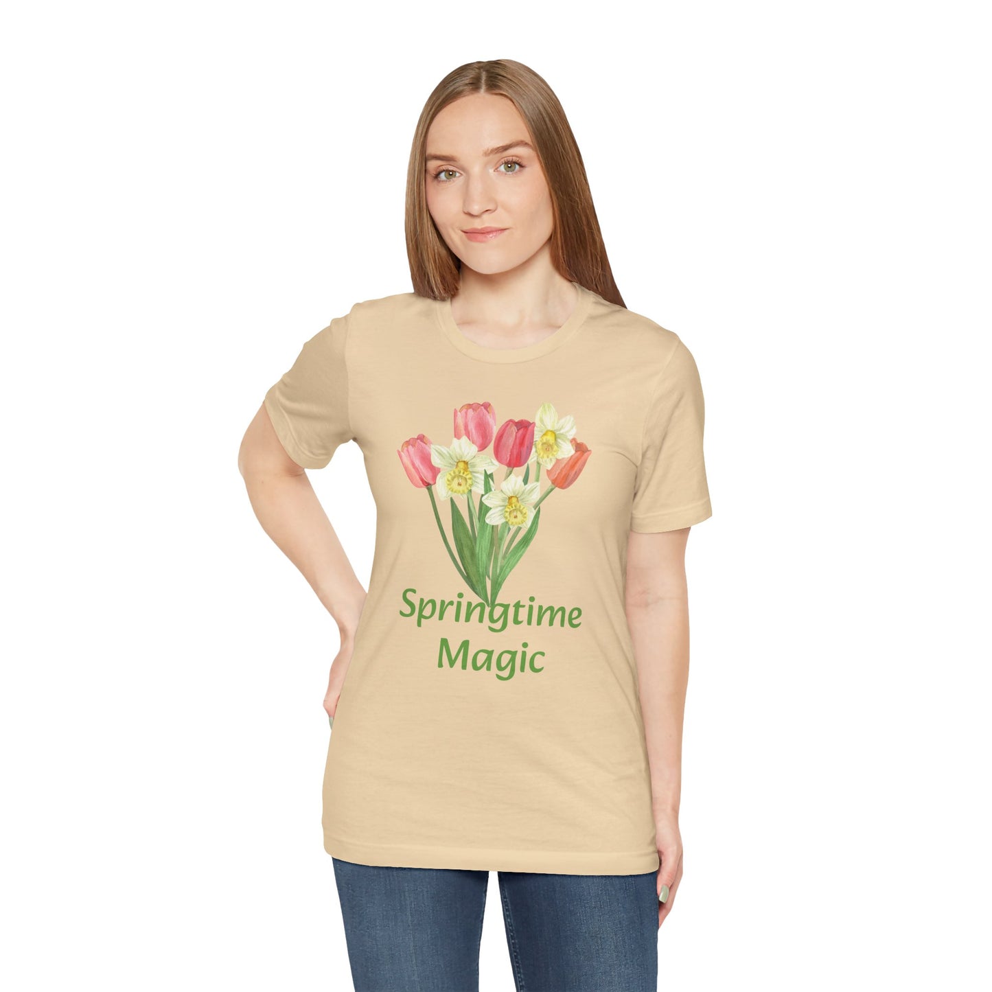 Woman wearing a beige cotton Unisex Springtime-Magic T-shirt with a tulip design and the text "springtime magic" from Bella + Canvas by Printify.