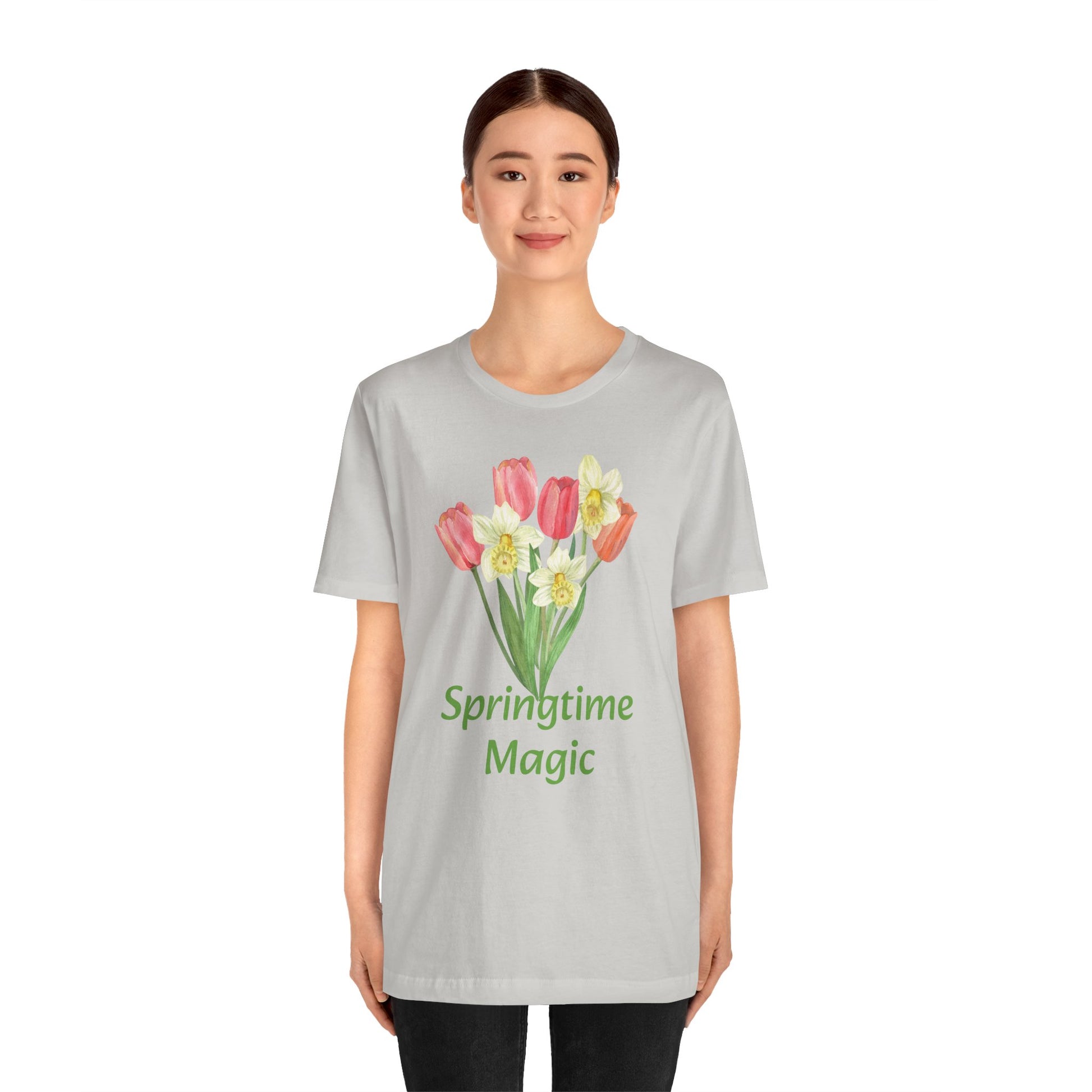 Woman wearing a gray Unisex Springtime-Magic T-shirt with a tulip design and the text "springtime magic" from Printify.