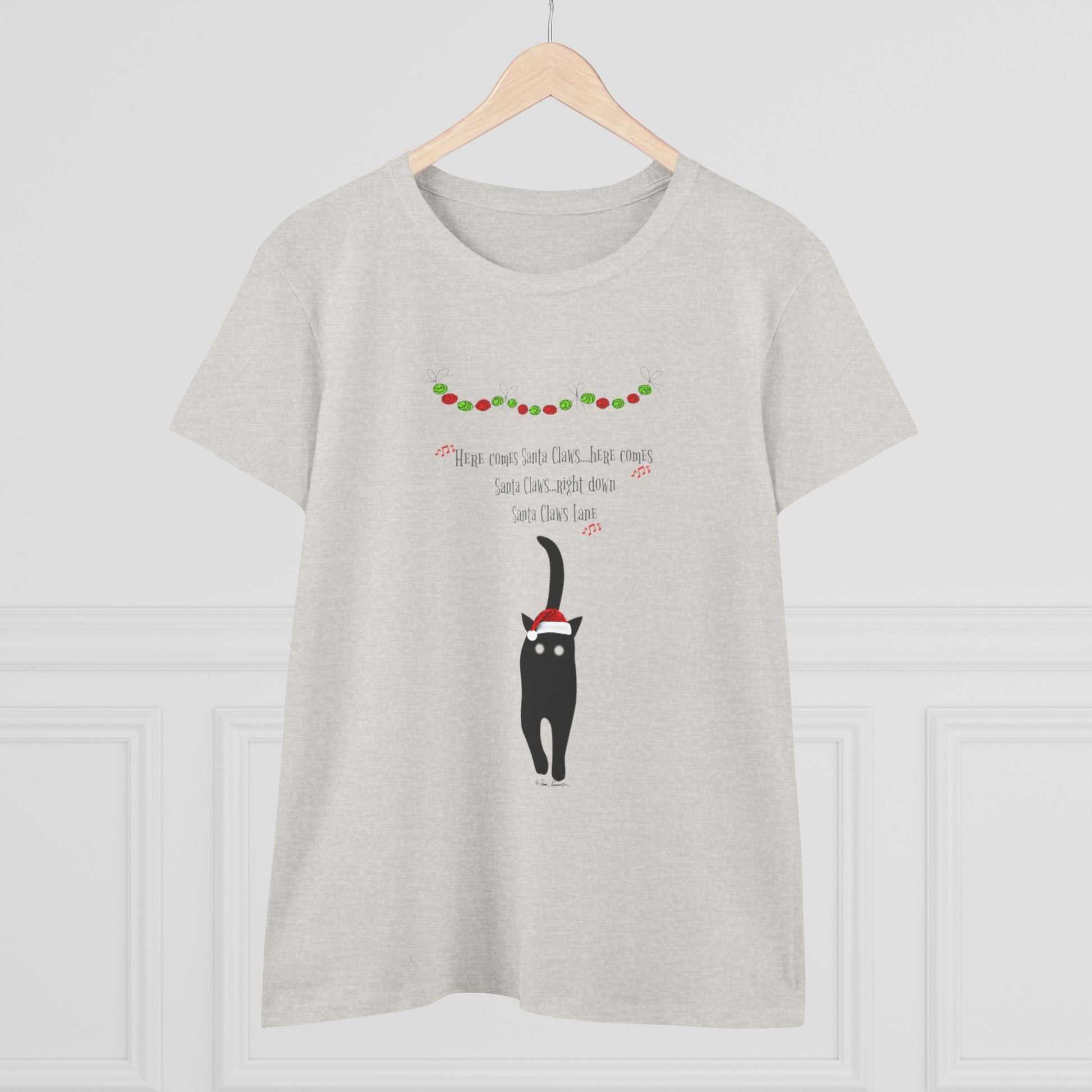 The Santa Claws T-shirt for women by Printify features a playful black cat in a Santa hat with Christmas garland—perfect festive cotton shirt for cat lovers.