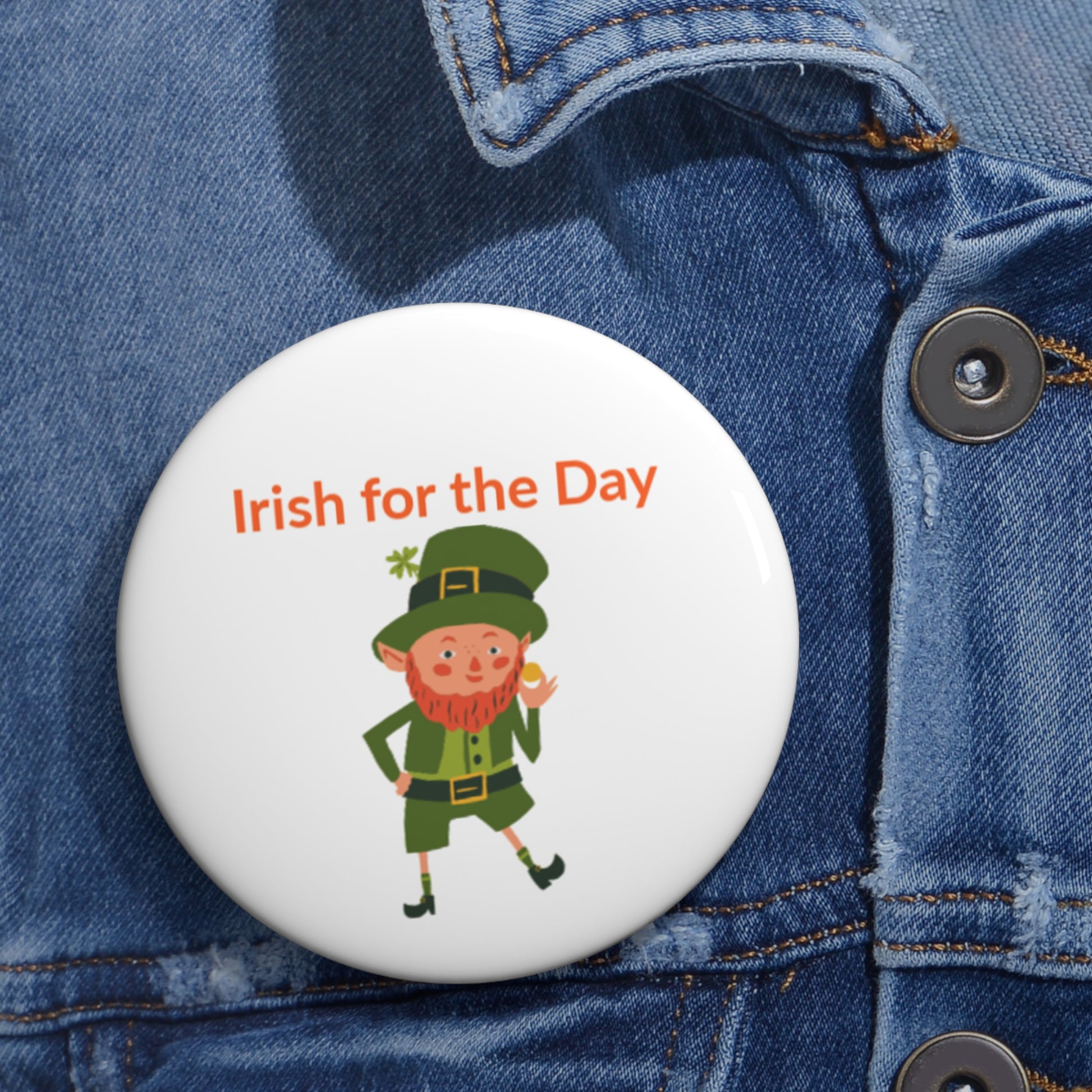 The Printify Irish-for-the-Day Pin Button features a leprechaun illustration and "Irish for the Day" in orange, available in 3 sizes—perfect for celebrating St. Patrick's Day.