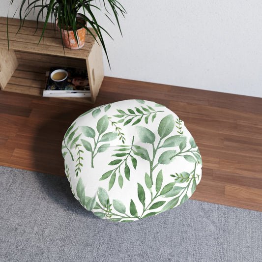  Printify round tufted floor pillow with a green botanical design on a wooden floor next to a potted plant and a coffee mug.