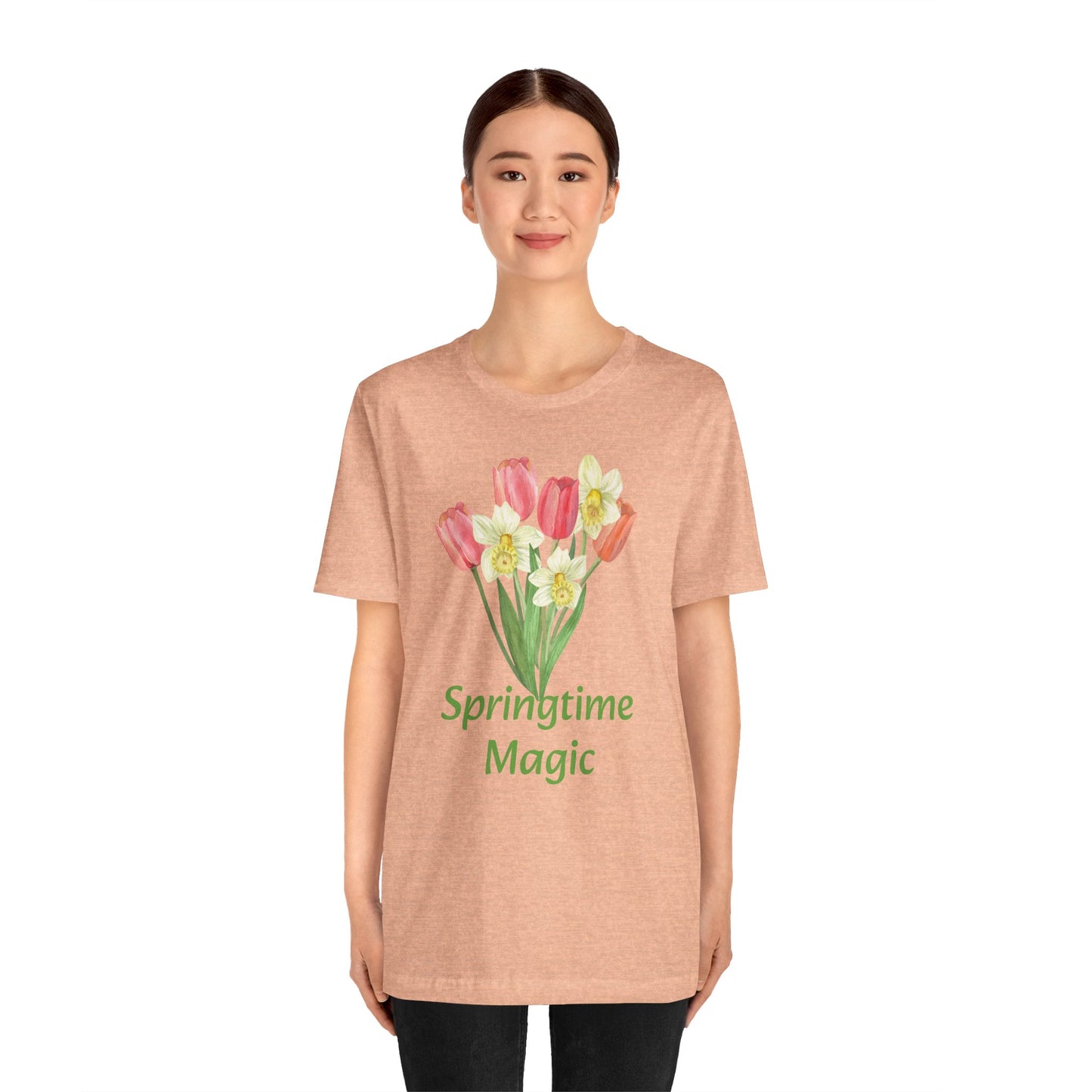 Woman in a beige cotton Unisex Springtime-Magic T-shirt showcasing graphic artistry by Bella + Canvas from Printify.