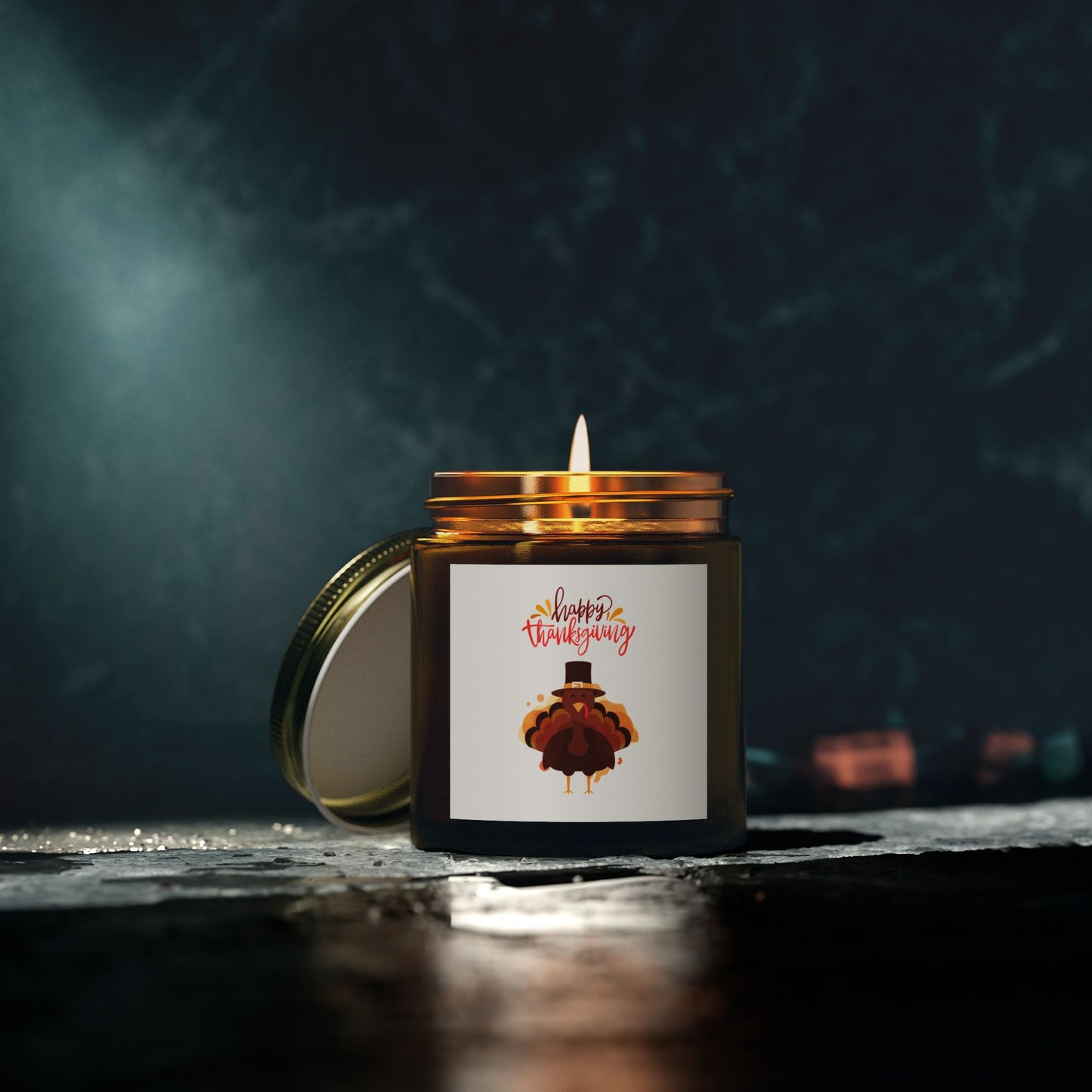 The Printify Thanksgiving Scented Candle (4 oz., 20 hrs) with Coconut Apricot Wax sits in an amber jar with a turkey label on a dark surface; its eco-friendly lid is beside it.