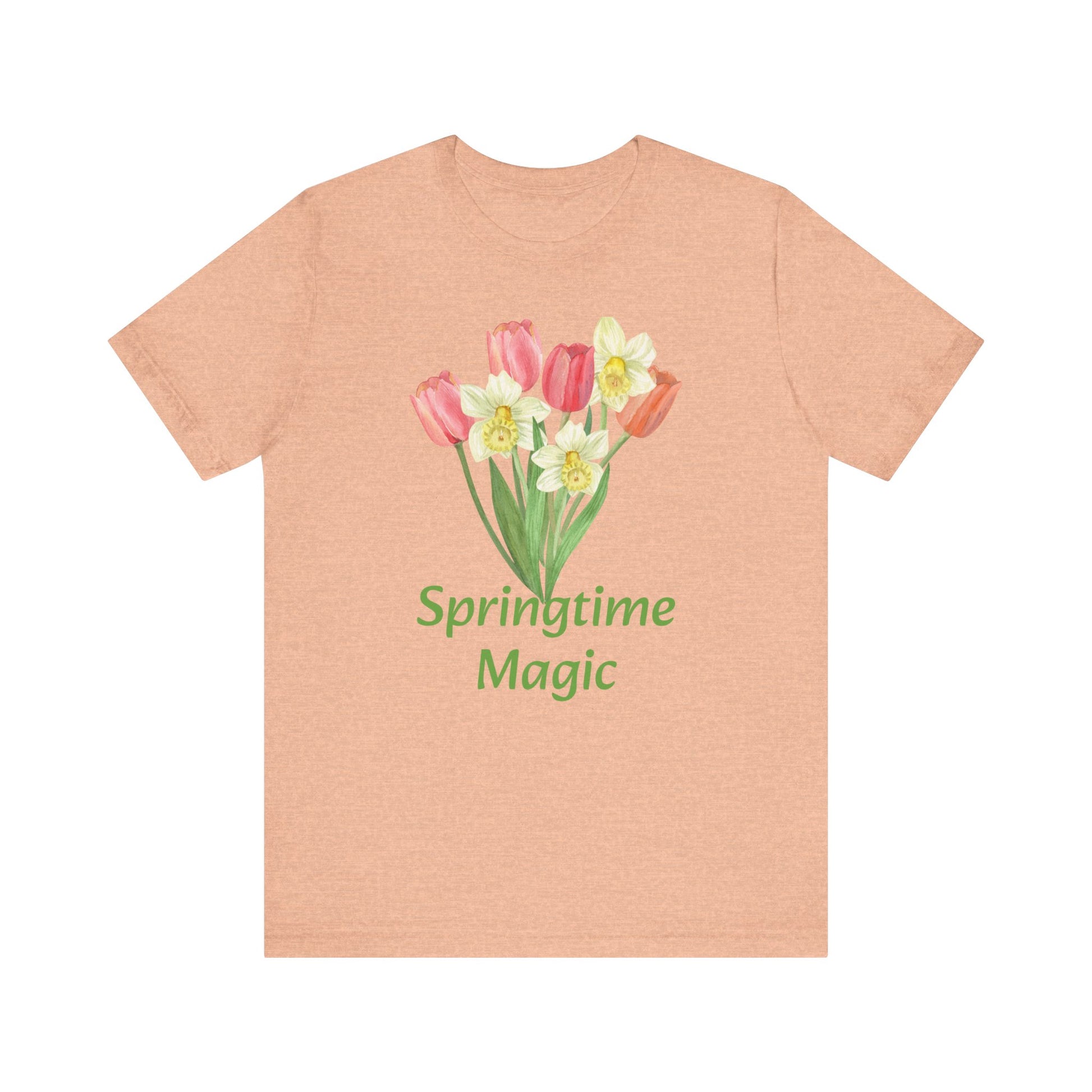A peach-colored cotton T-shirt with a floral design and the text "springtime magic" from Printify's Unisex Springtime-Magic T-shirt by Bella + Canvas.