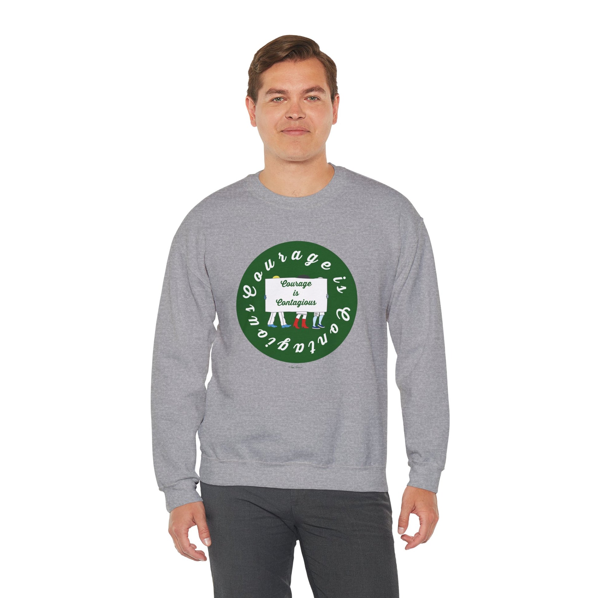 A man wears the Printify Unisex Crewneck Sweatshirt: Courage is Contagious | Protest in light gray, featuring a circular green and white front graphic saying "Courage is contagious"—ideal for fans of inspirational apparel.