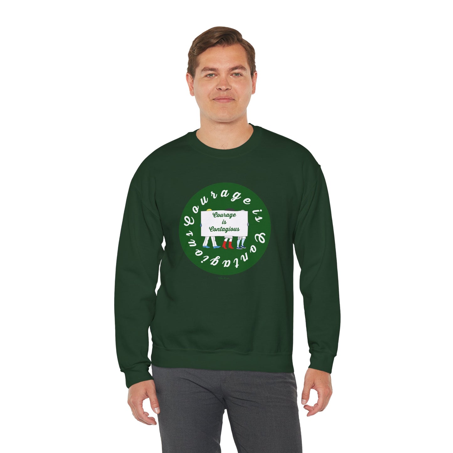 A man wears the Printify Unisex Crewneck Sweatshirt: Courage is Contagious | Protest, featuring a dark green color, circular design, and the words "Courage is contagious" on the front.