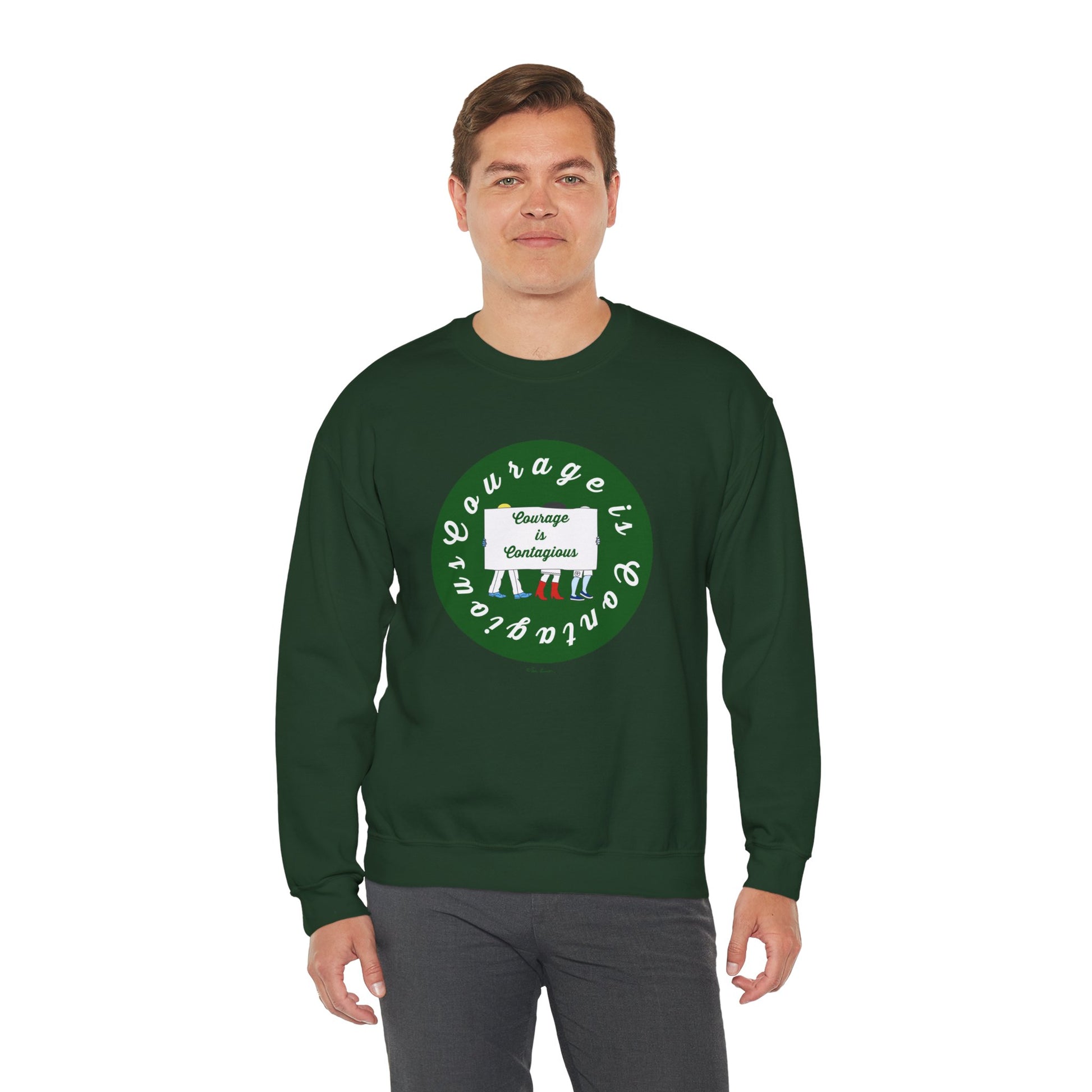 A man wears the Printify Unisex Crewneck Sweatshirt: Courage is Contagious | Protest, featuring a dark green color, circular design, and the words "Courage is contagious" on the front.