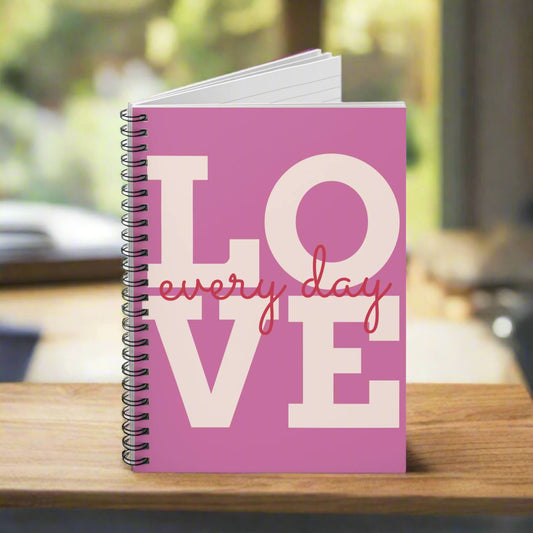 The Love Every-Day Spiral Notebook by Printify is a 6x8 unisex journal with ruled lines, vibrant pink cover, metal spiral binding, and "LOVE every day" in bold letters.