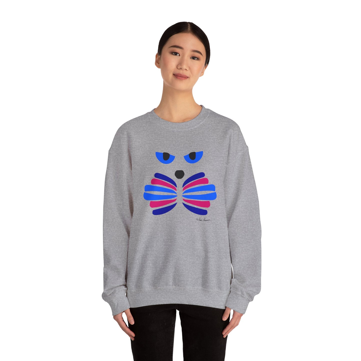 A person wears the Printify Whimsical Cat Graphic Sweatshirt, a unisex crewneck featuring an artistic cat design with an abstract face and bow tie in blue, pink, and purple.
