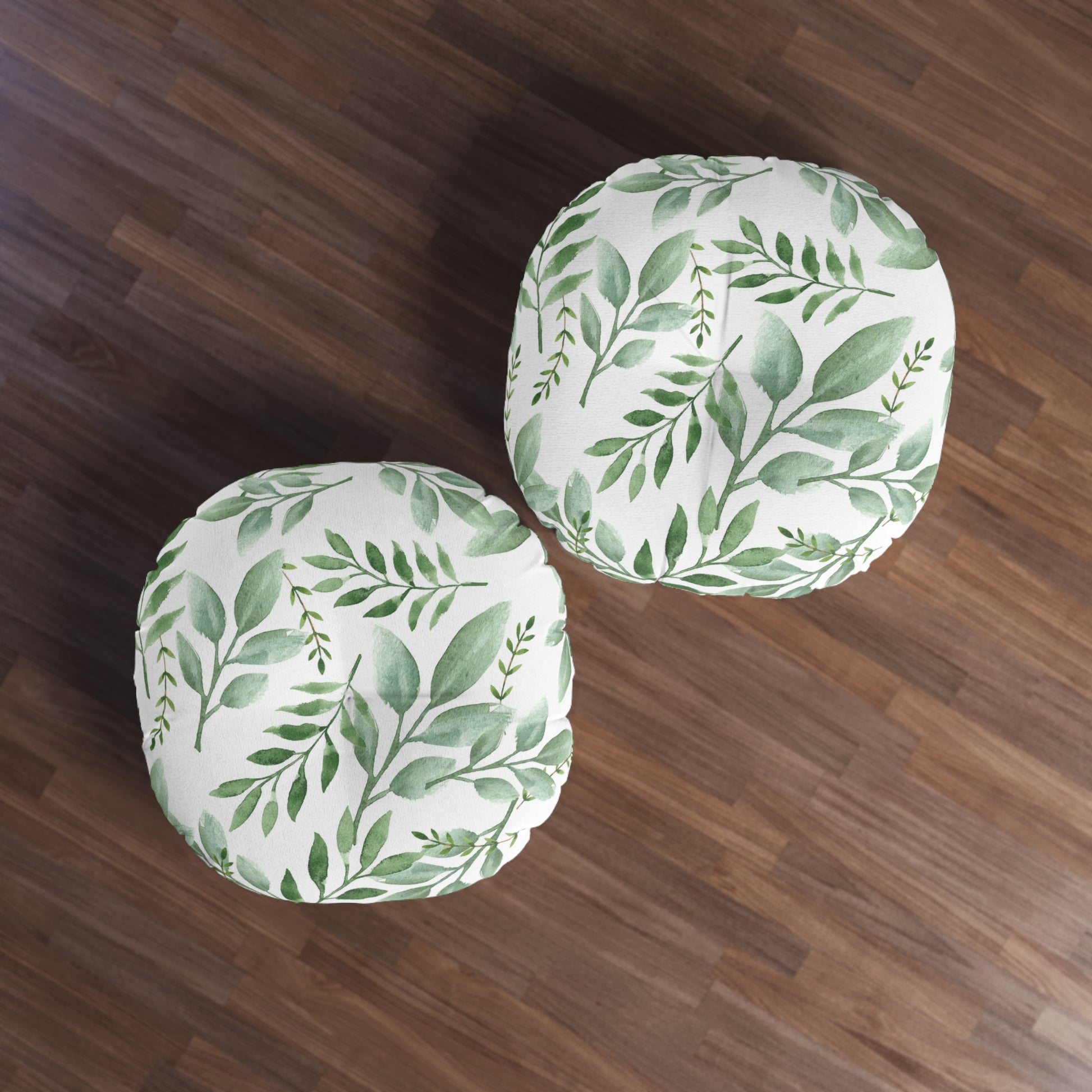 Two Printify round tufted floor-pillows with green botanical design on a wooden floor.