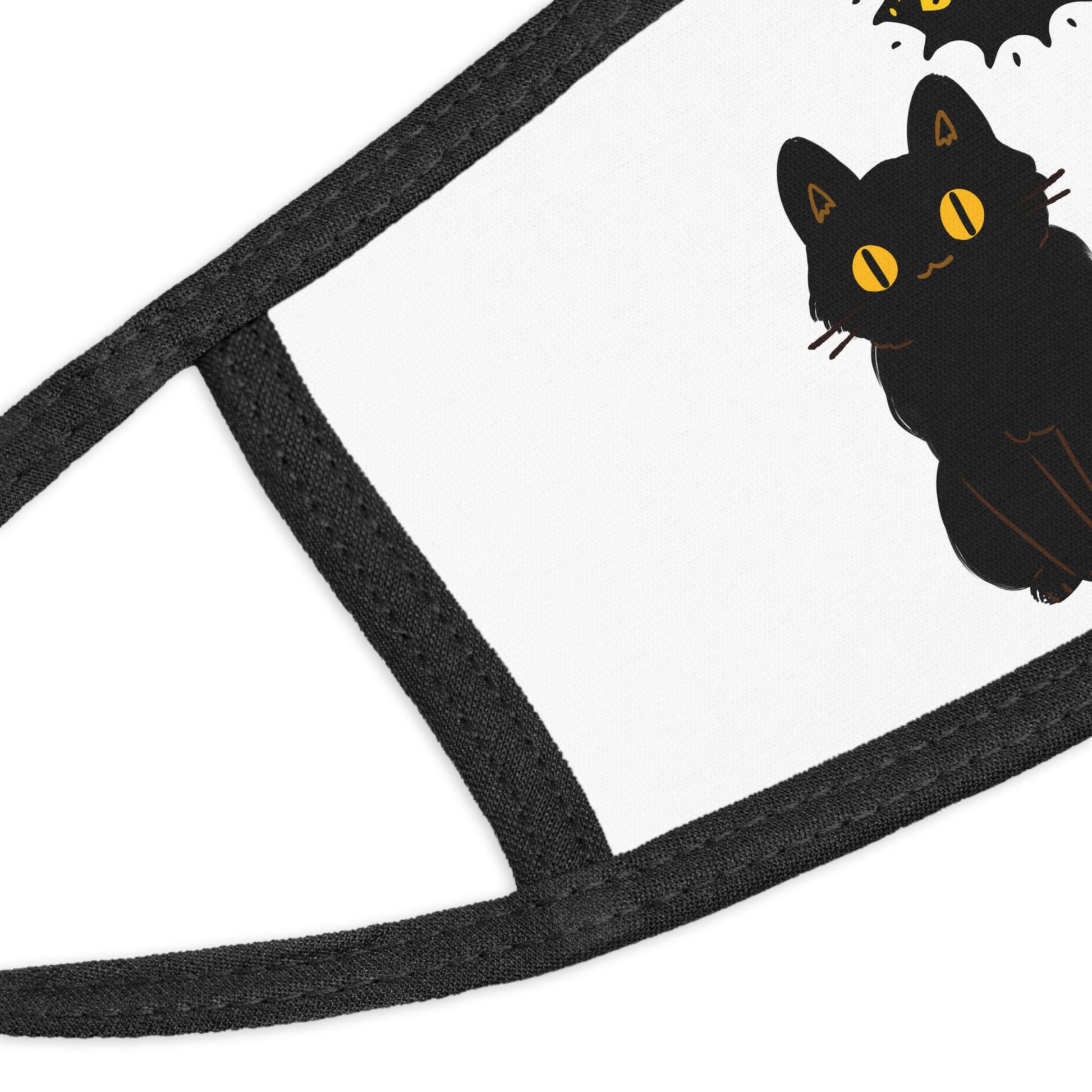 Close-up of the Adorable Kids' Black-Cat Face-Mask: Halloween Costume by Printify, featuring a black cat with yellow eyes and a small bat print—perfect as a kids' Halloween mask on a white background.