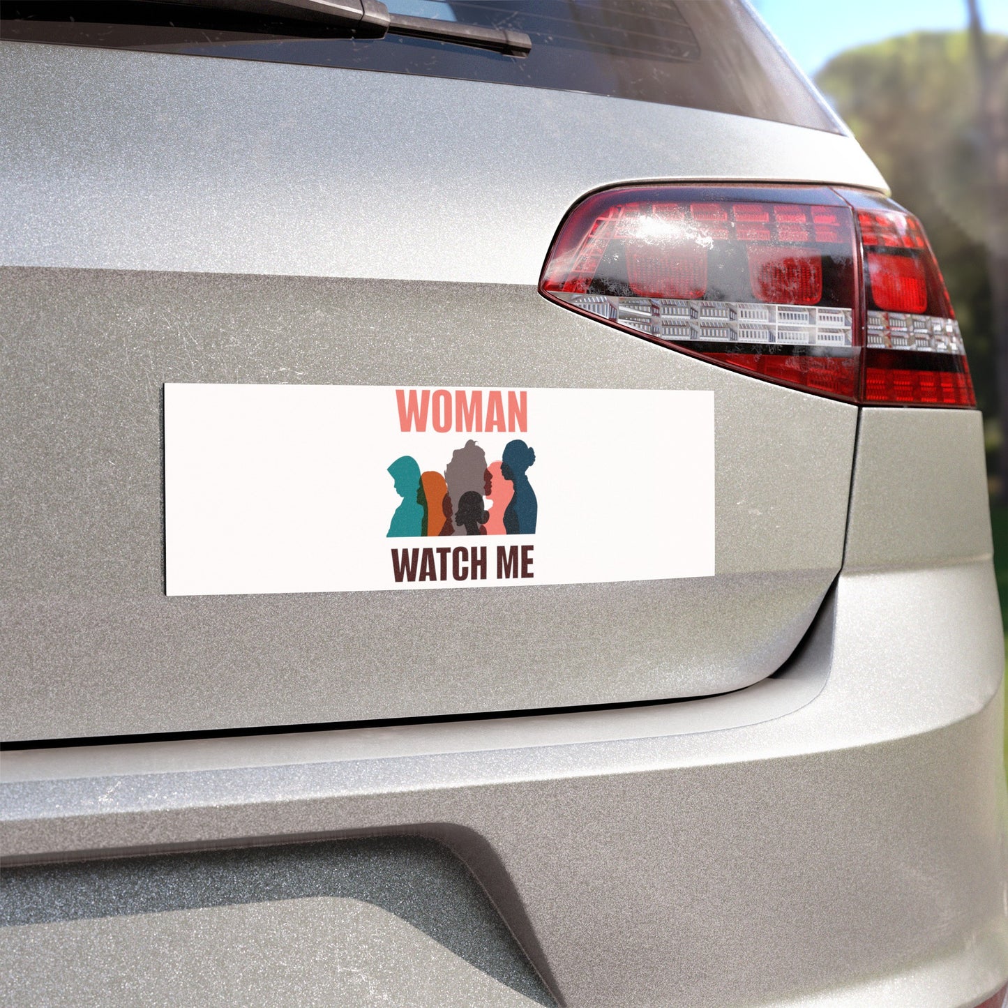 A silver vehicle features a weatherproof vinyl car magnet by Printify, displaying silhouettes of three women and the words "Woman Watch Me.