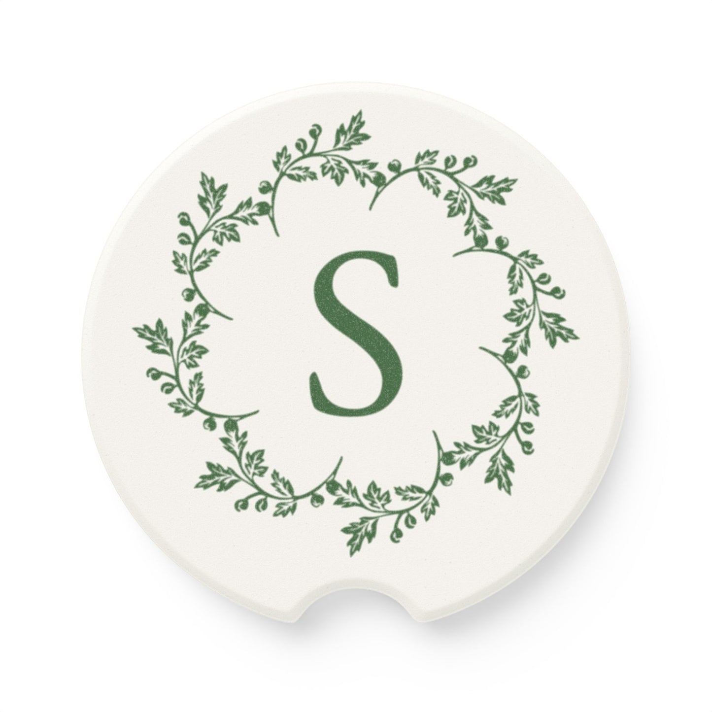 Printify's Personalized Car Coaster is a stylish and functional accessory for your vehicle. This unisex coaster features an elegant design, crafted from natural soapstone, with a central green letter "S" encircled by a wreath of green leaves set against a white background. It combines both elegance and functionality with its absorbent properties.