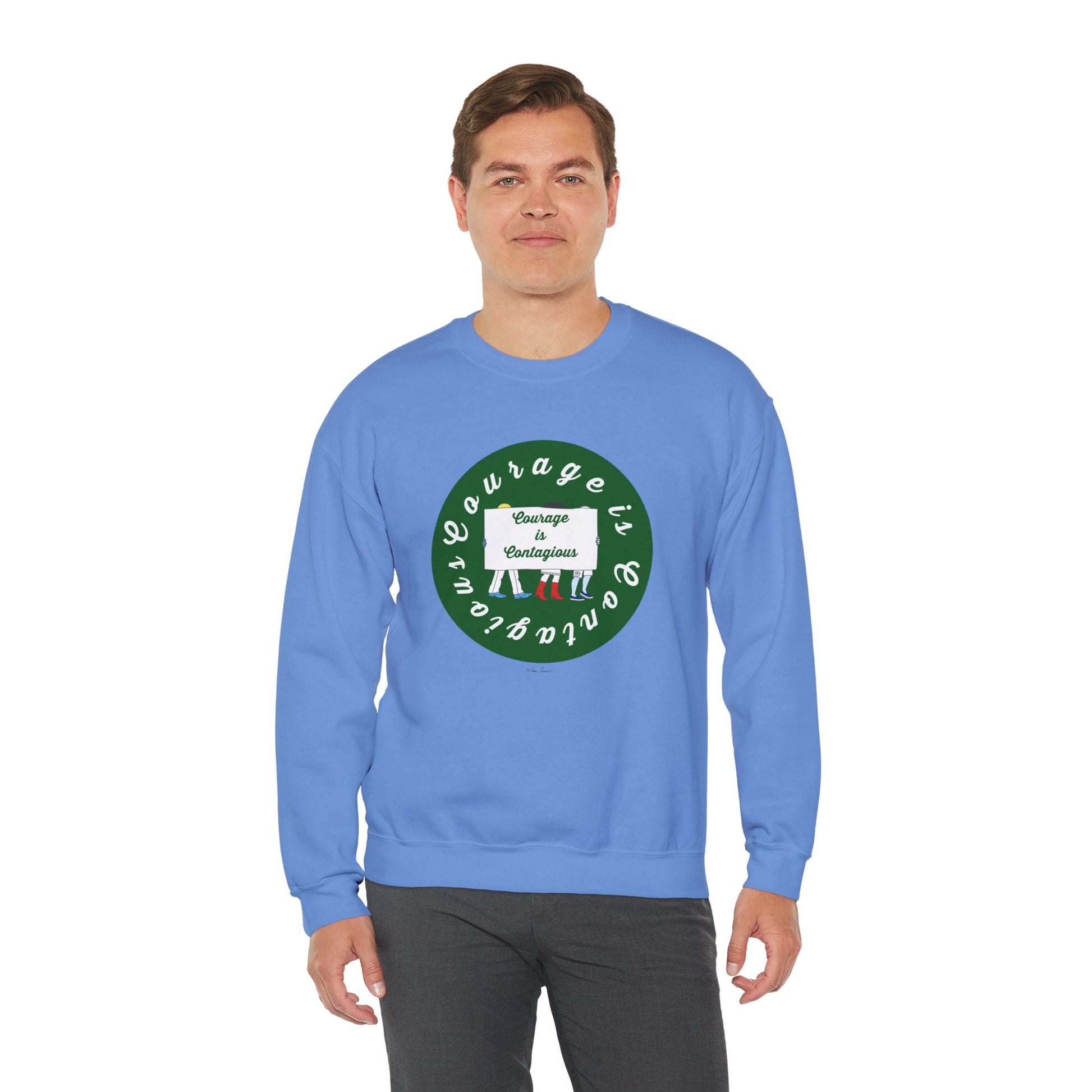 A man wears the Printify Unisex Crewneck Sweatshirt: Courage is Contagious | Protest, featuring a circular "Courage is contagious" graphic and unique design in light blue.