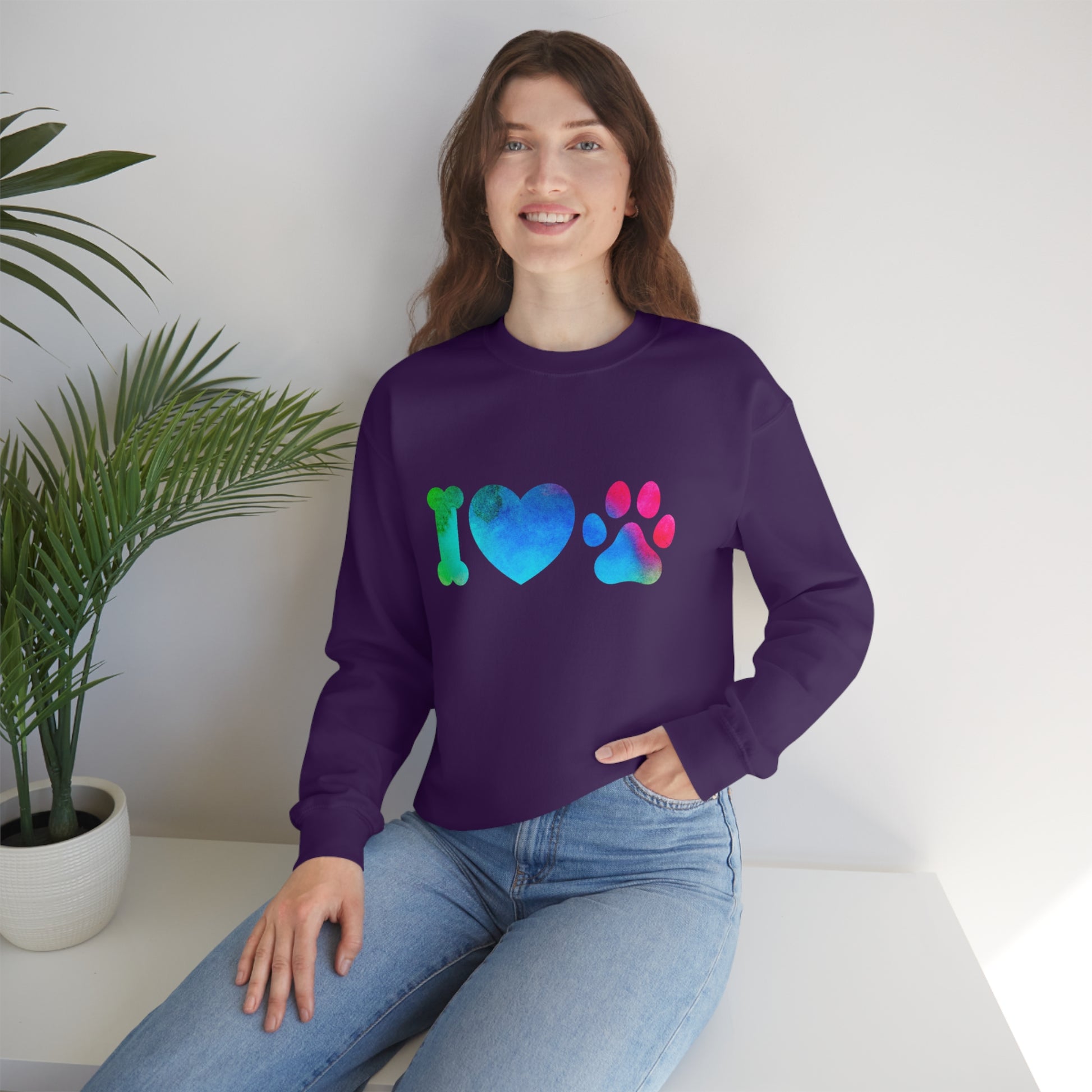 Mock up of a woman sitting on a surface while wearing the Purple sweatshirt