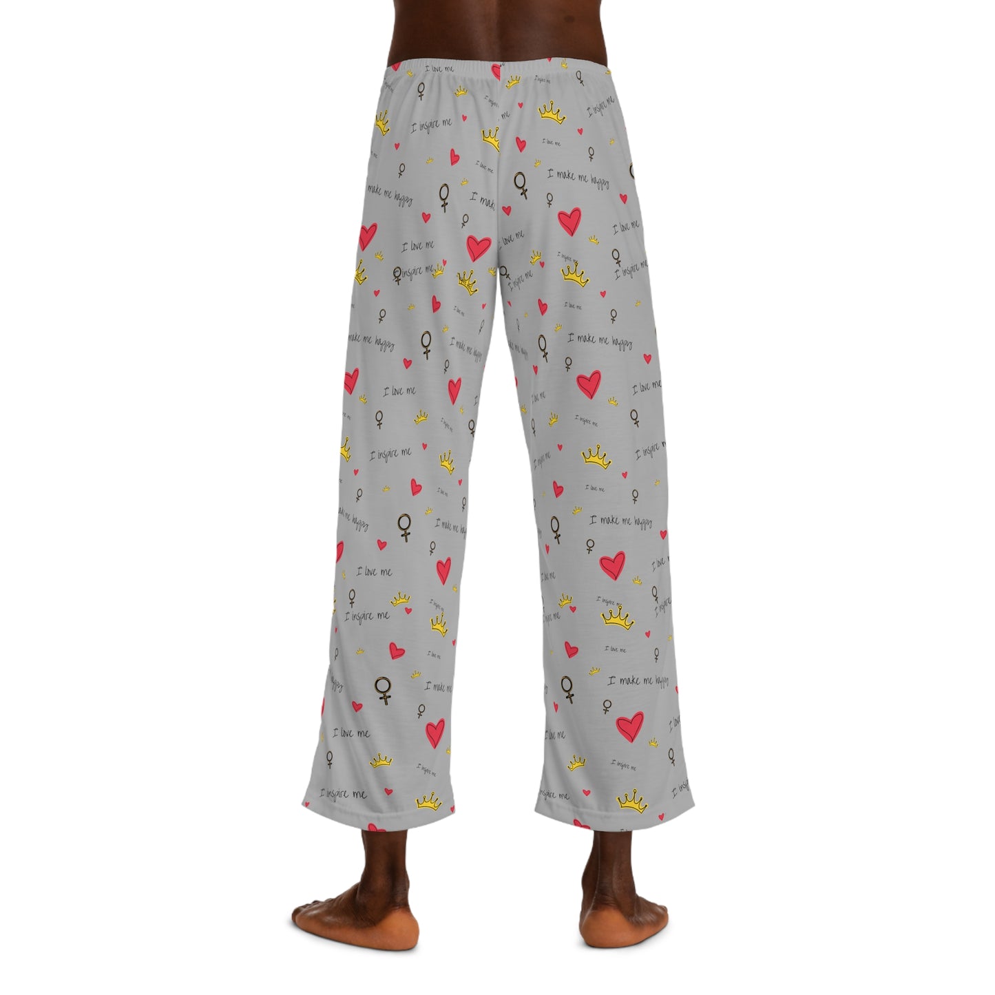 A man wearing grey Printify pajama pants with hearts on them, perfect as a Valentine's Day gift. These 100% polyester Printify men's pajama pants are comfortable and stylish.